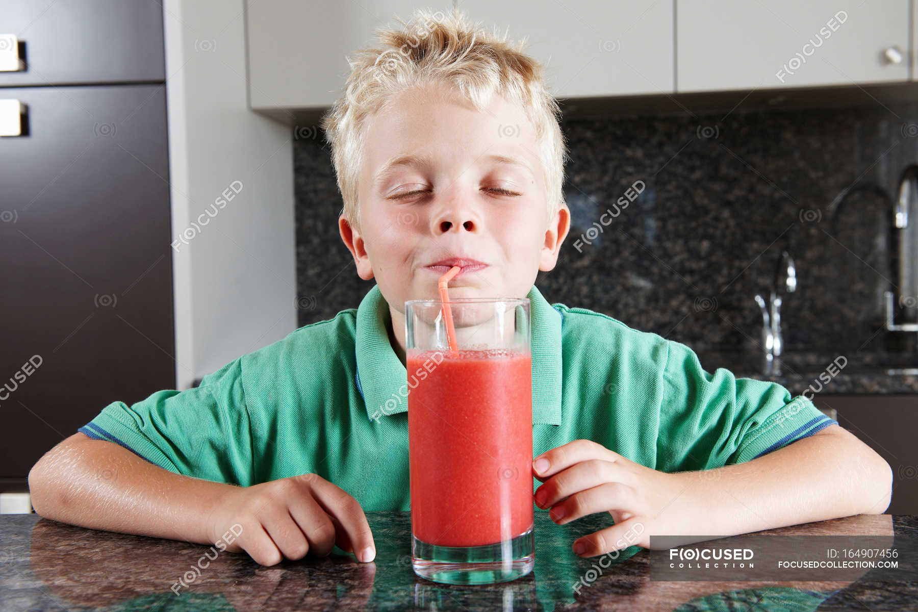 Boy drinking fruit juice with straw — adorable, childhood - Stock Photo