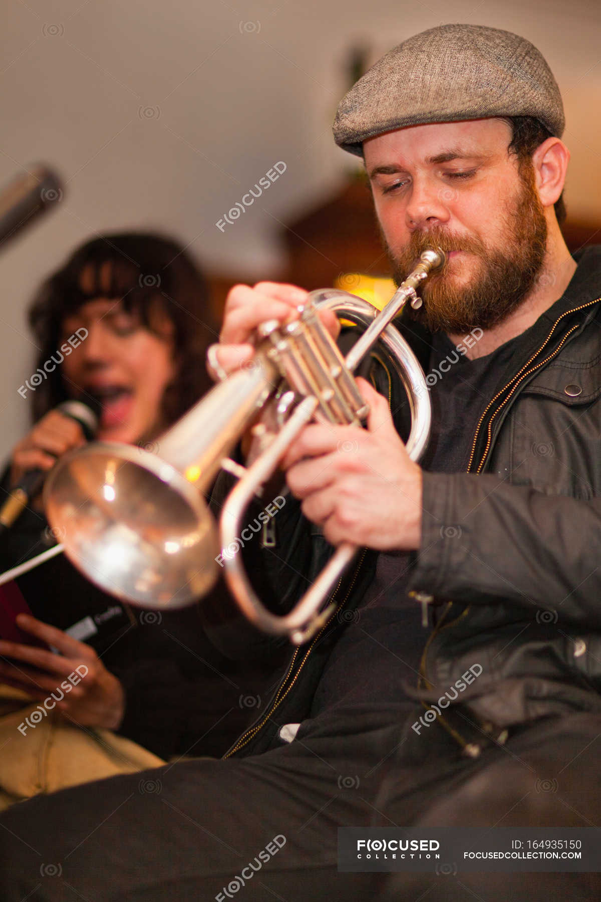 Trumpet player practicing with band — holding, performer Stock Photo