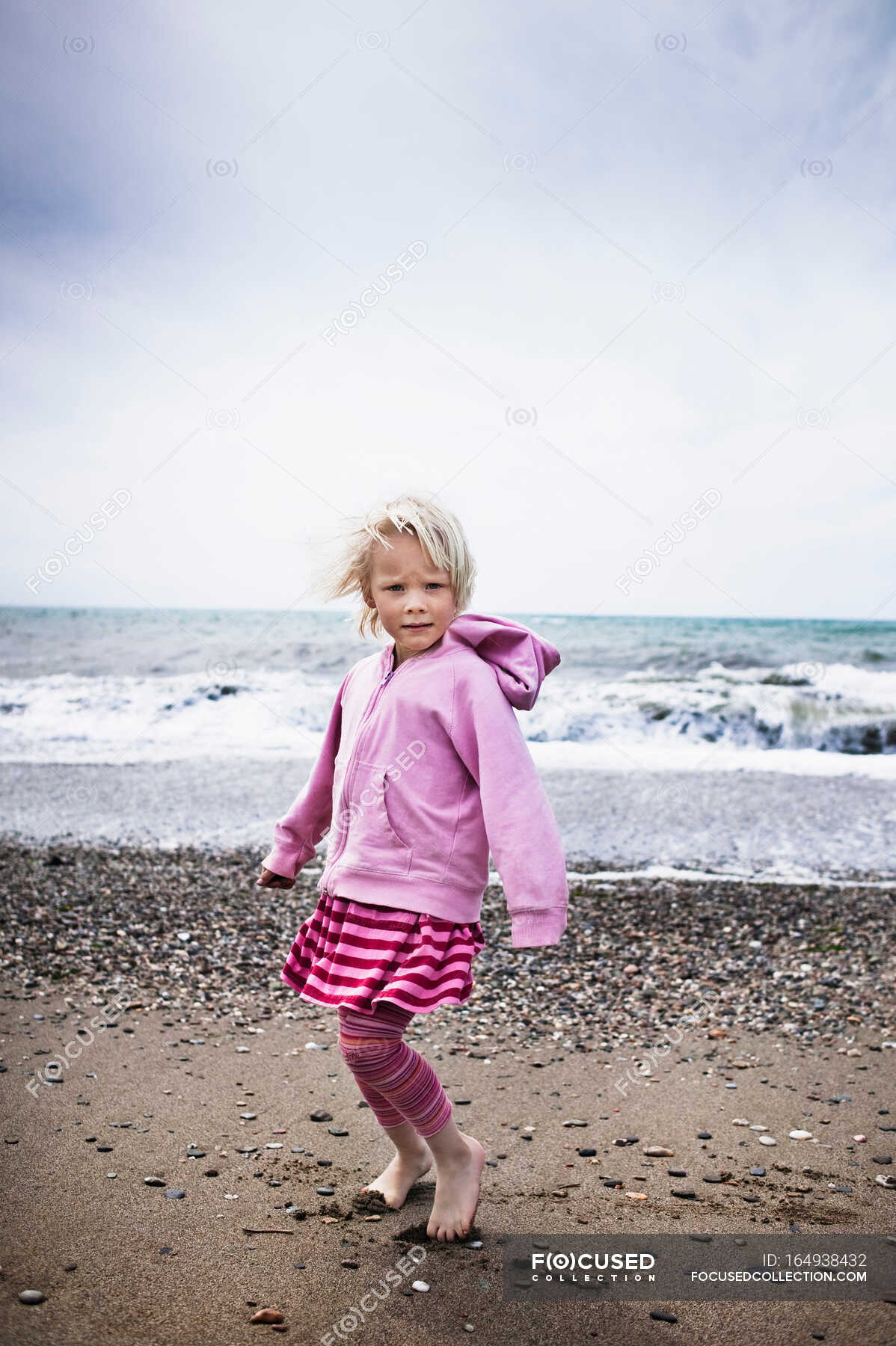 Girl walking barefoot on the beach — copy space, motion - Stock Photo ...