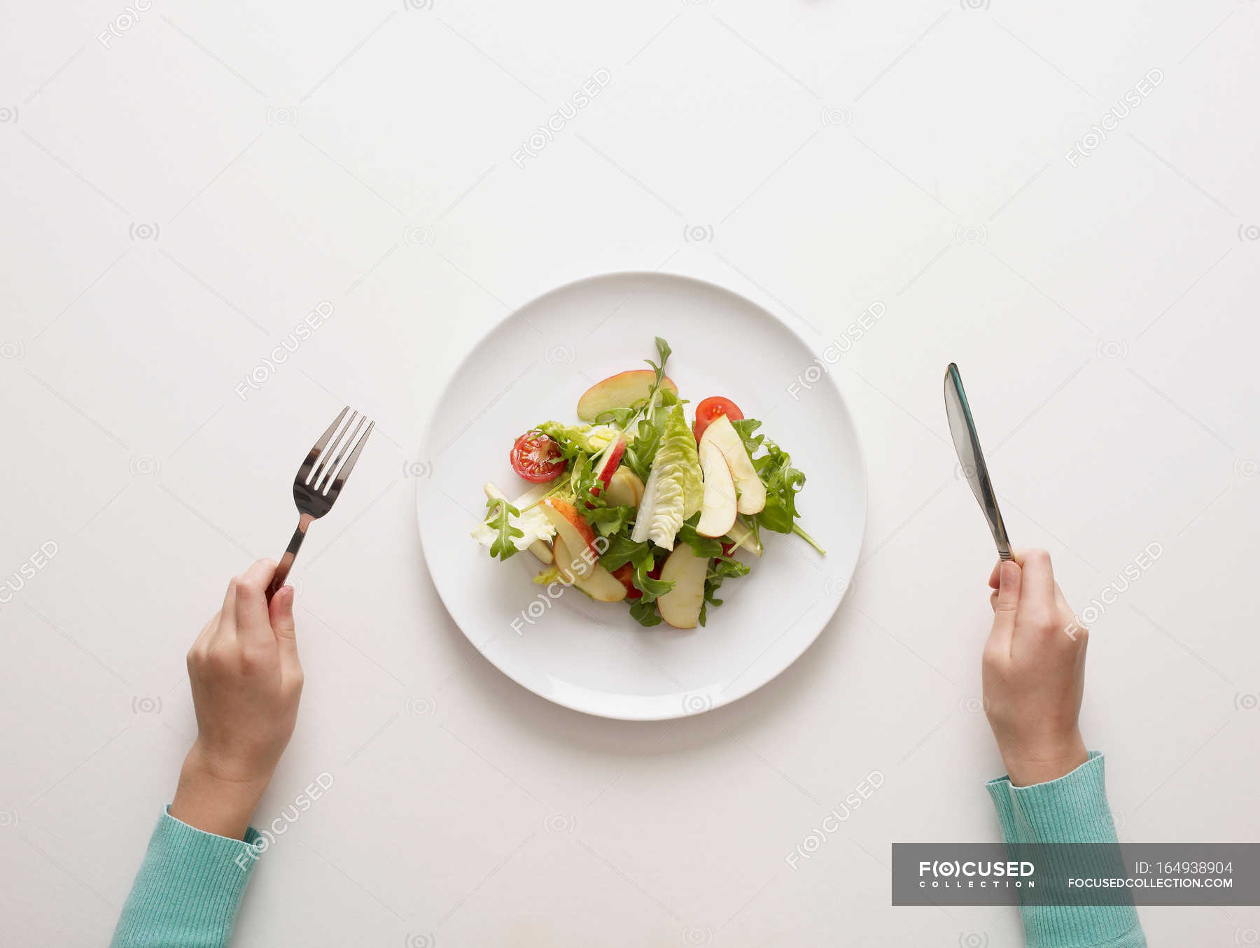 hands-holding-fork-and-knife-by-salad-10-to-12-years-nutrition