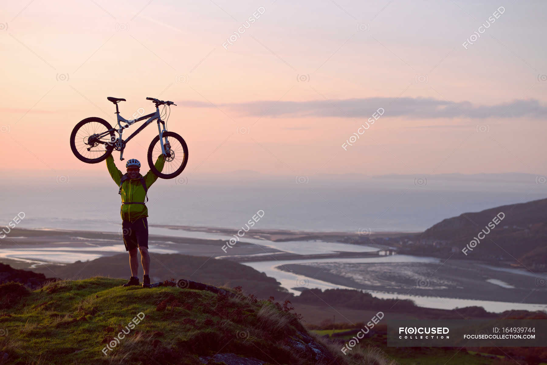 Man holding bicycle on hilltop — protection, north wales - Stock Photo ...