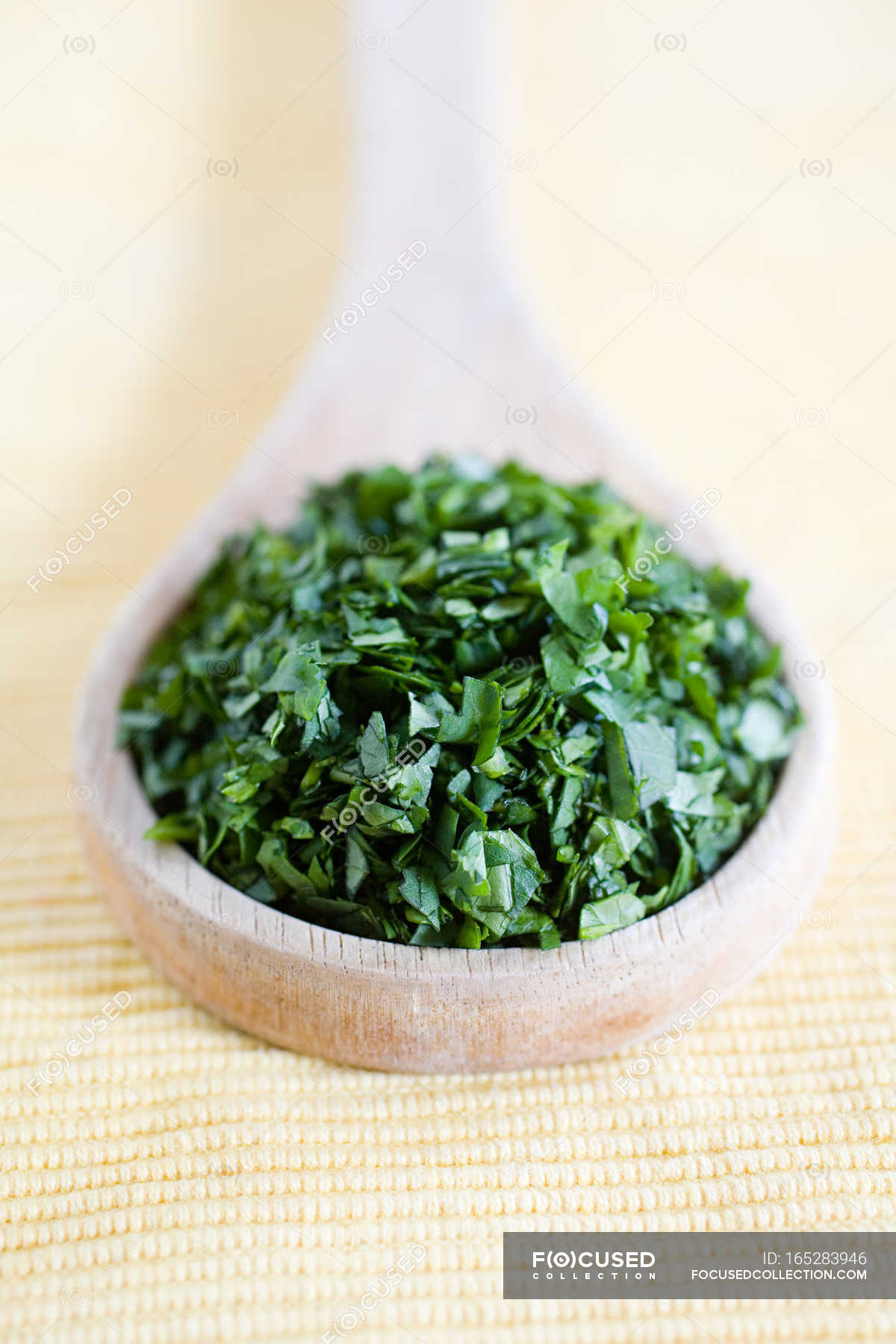 Chopped cilantro on wooden board close-up Stock Photo by ©belchonock  44324281