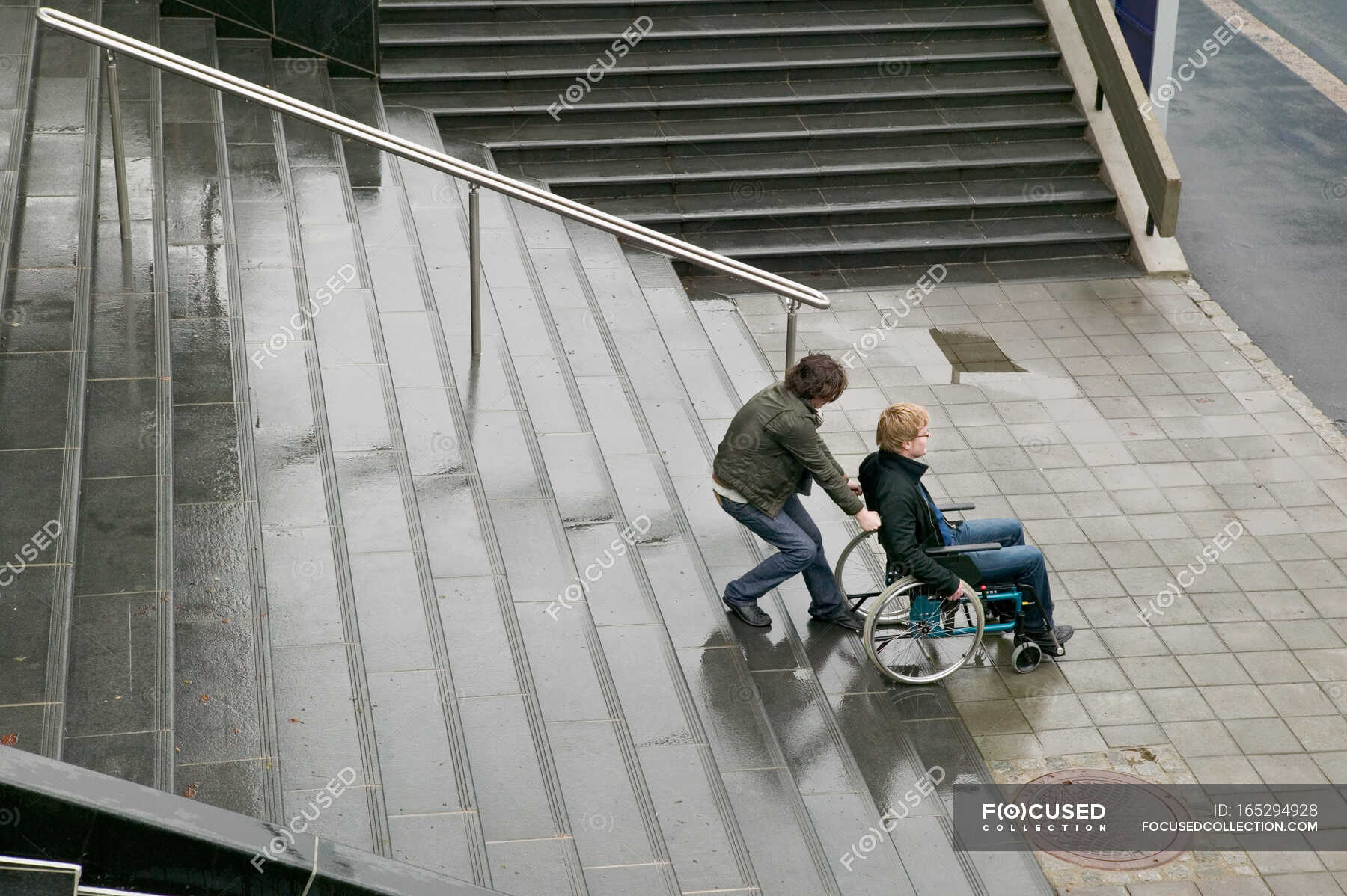 Man helping disabled person up stairway — Two People, effort - Stock ...