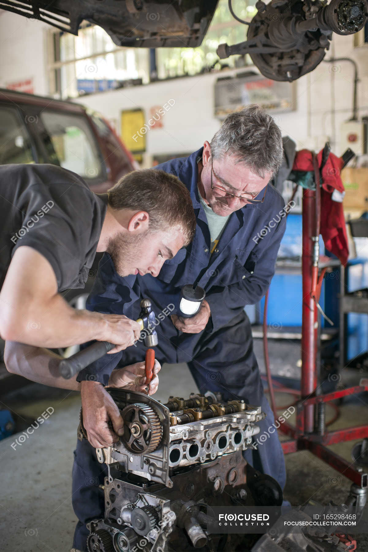 Mechanics working on car engine in garage — man, teaching - Stock Photo ...