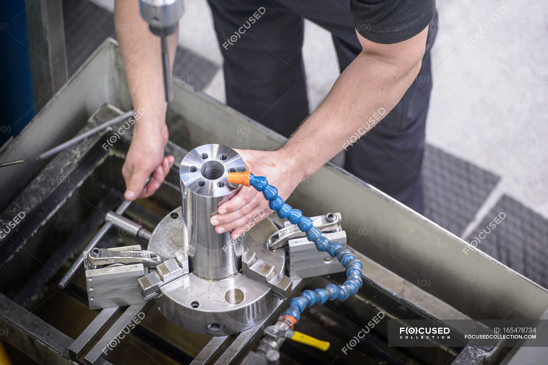 Engineer drilling steel rod for industry — Manufacturing Plant