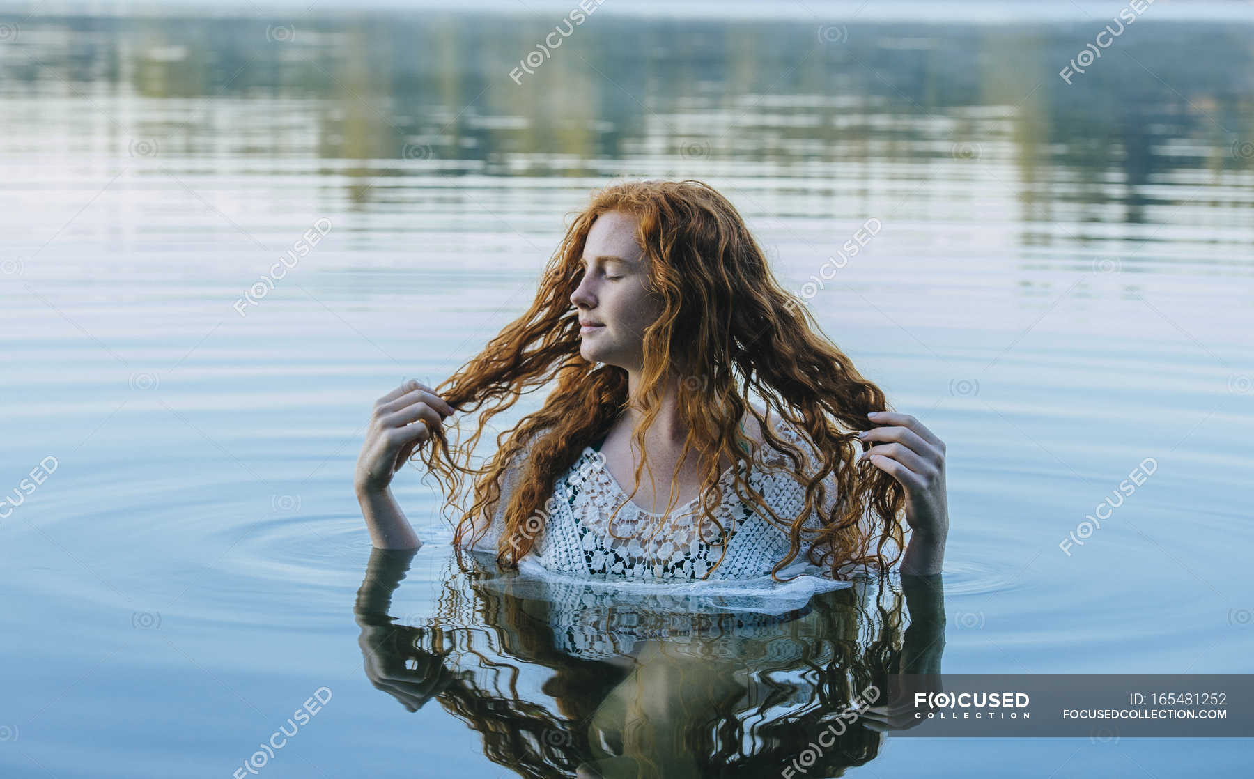 Head And Shoulders Of Beautiful Young Woman With Long Red Hair In