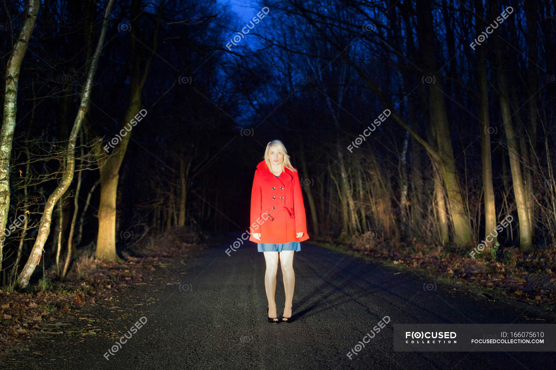 Woman Standing On Road In Woods At Night Outdoors Fear Stock Photo