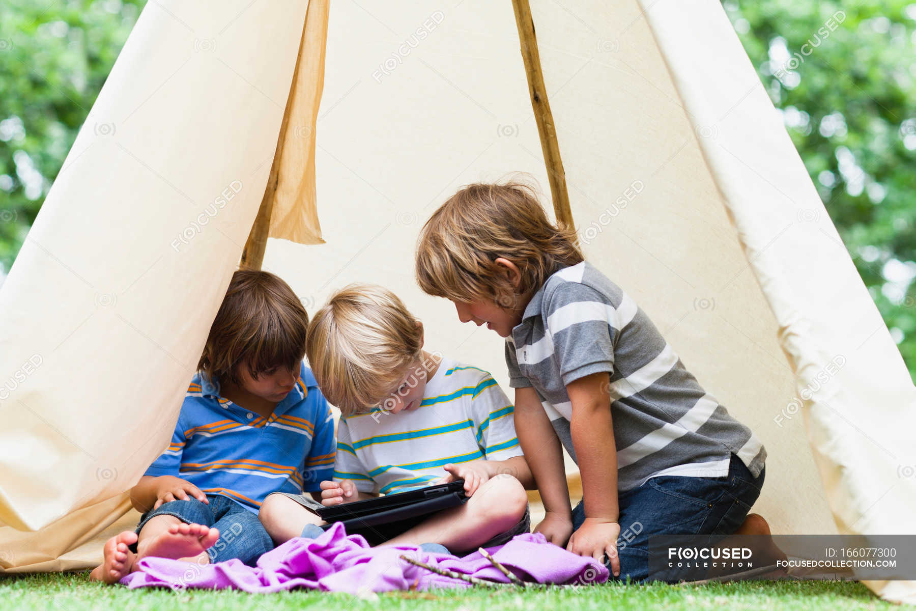 Boys using tablet computer in tent — summer, mobility - Stock Photo ...