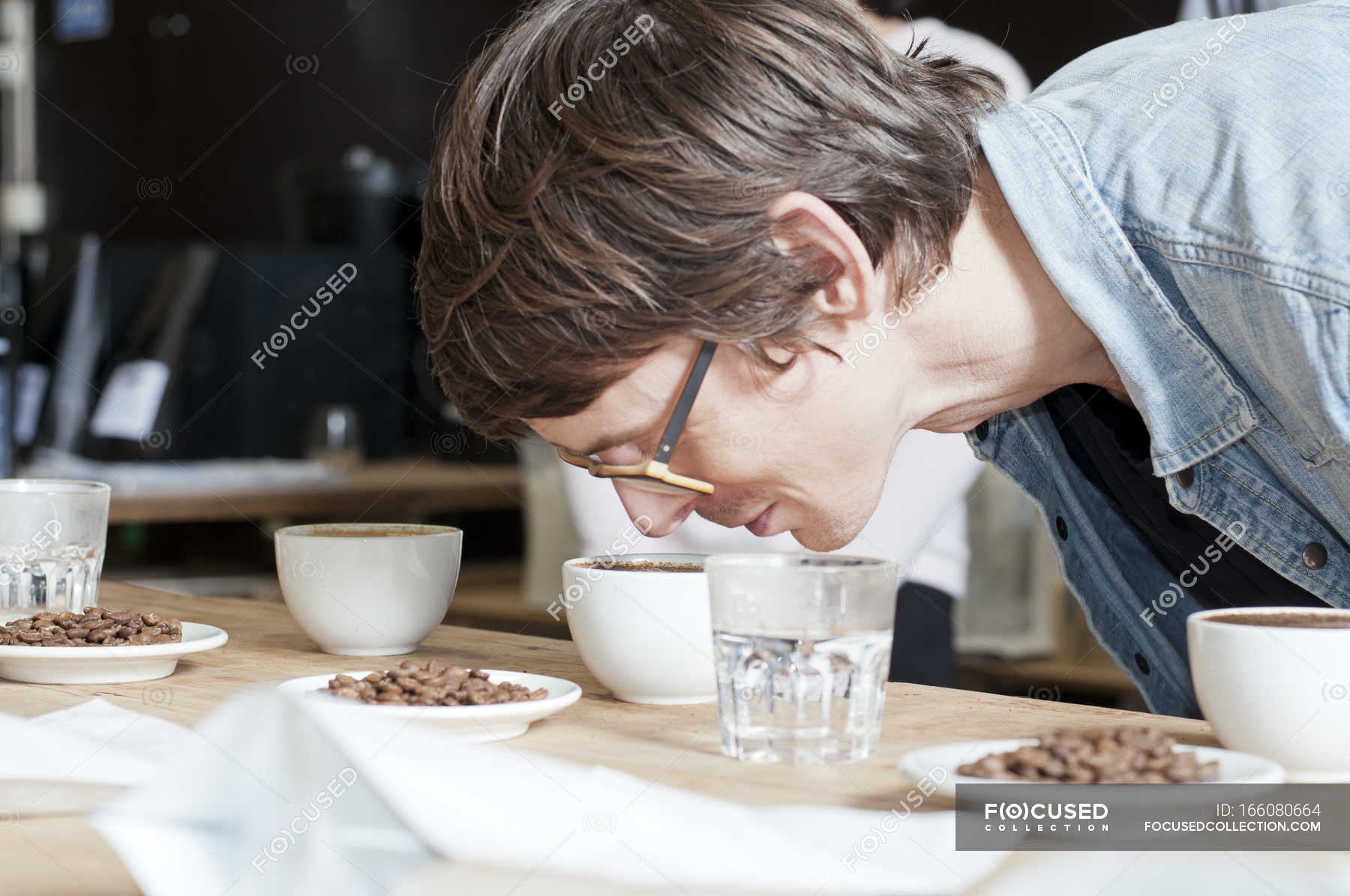 Coffee taster smelling cup of coffee — teamwork, connoisseur Stock