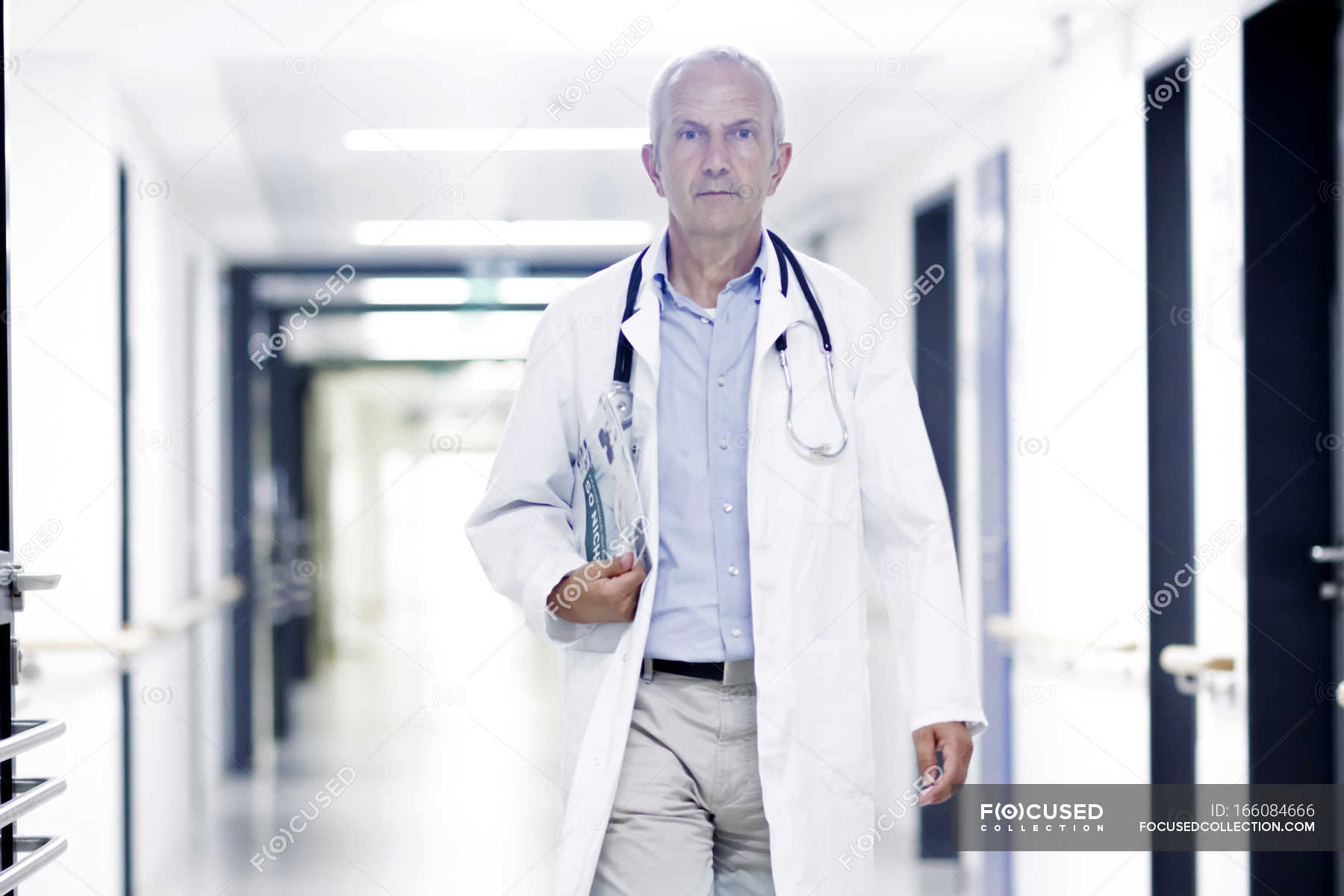 Male doctor walking along corridor — differential, science collection ...