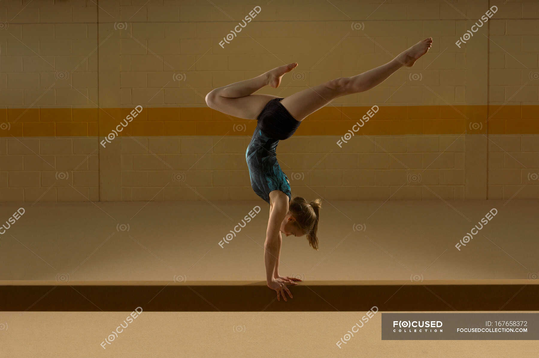 Teenage gymnast on beam — only female, horizontal - Stock Photo ...