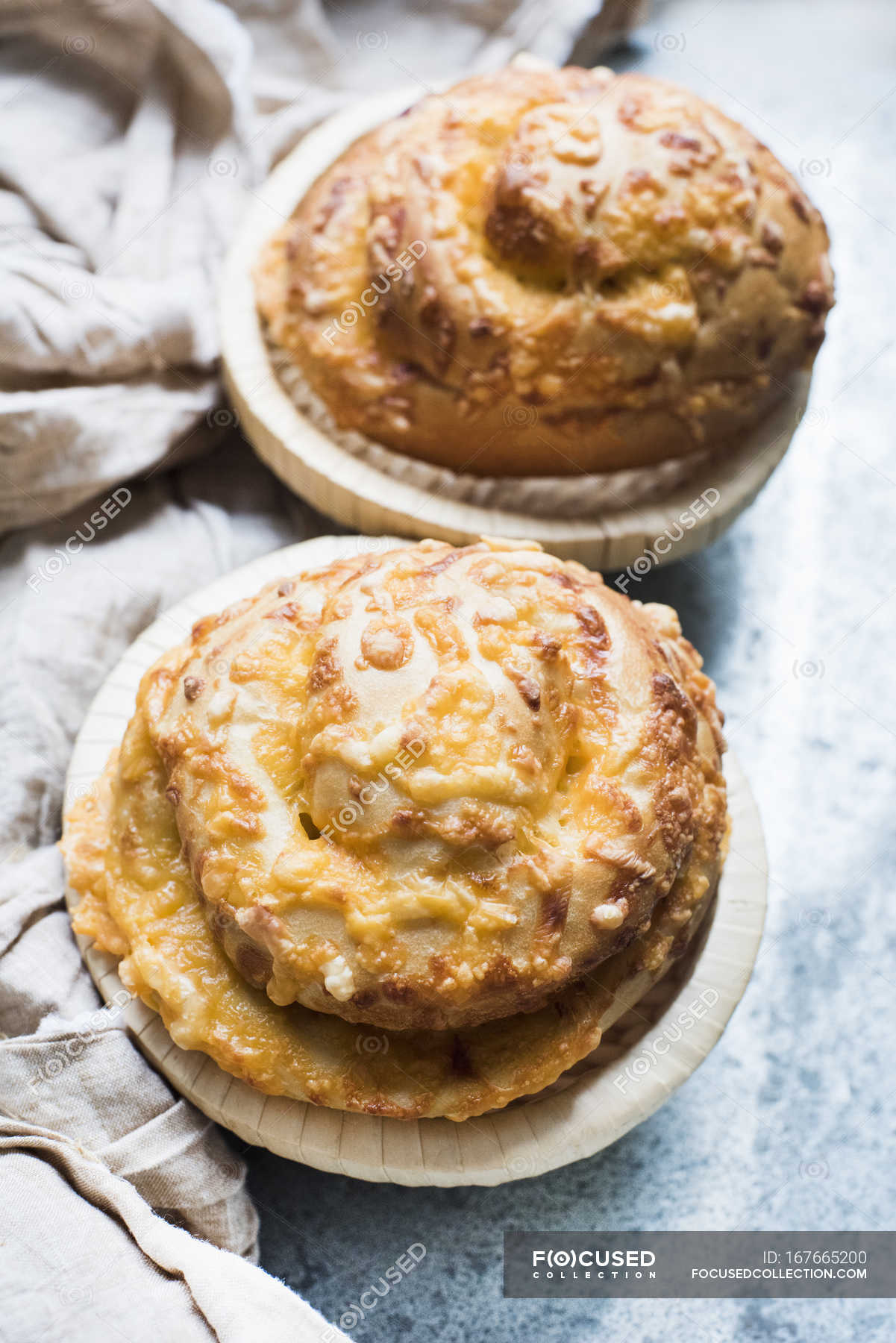 Close up of freshly baked bread rolls with topped cheese