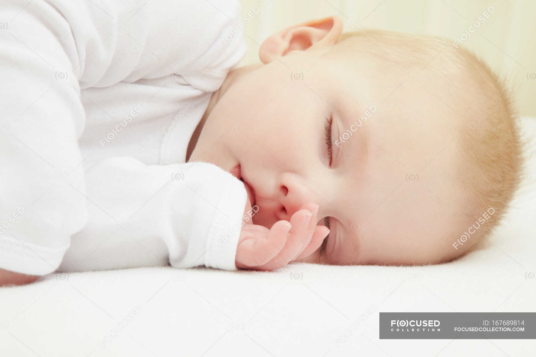 Baby Girl Sleeping In Crib Indoors Lifestyle Stock Photo