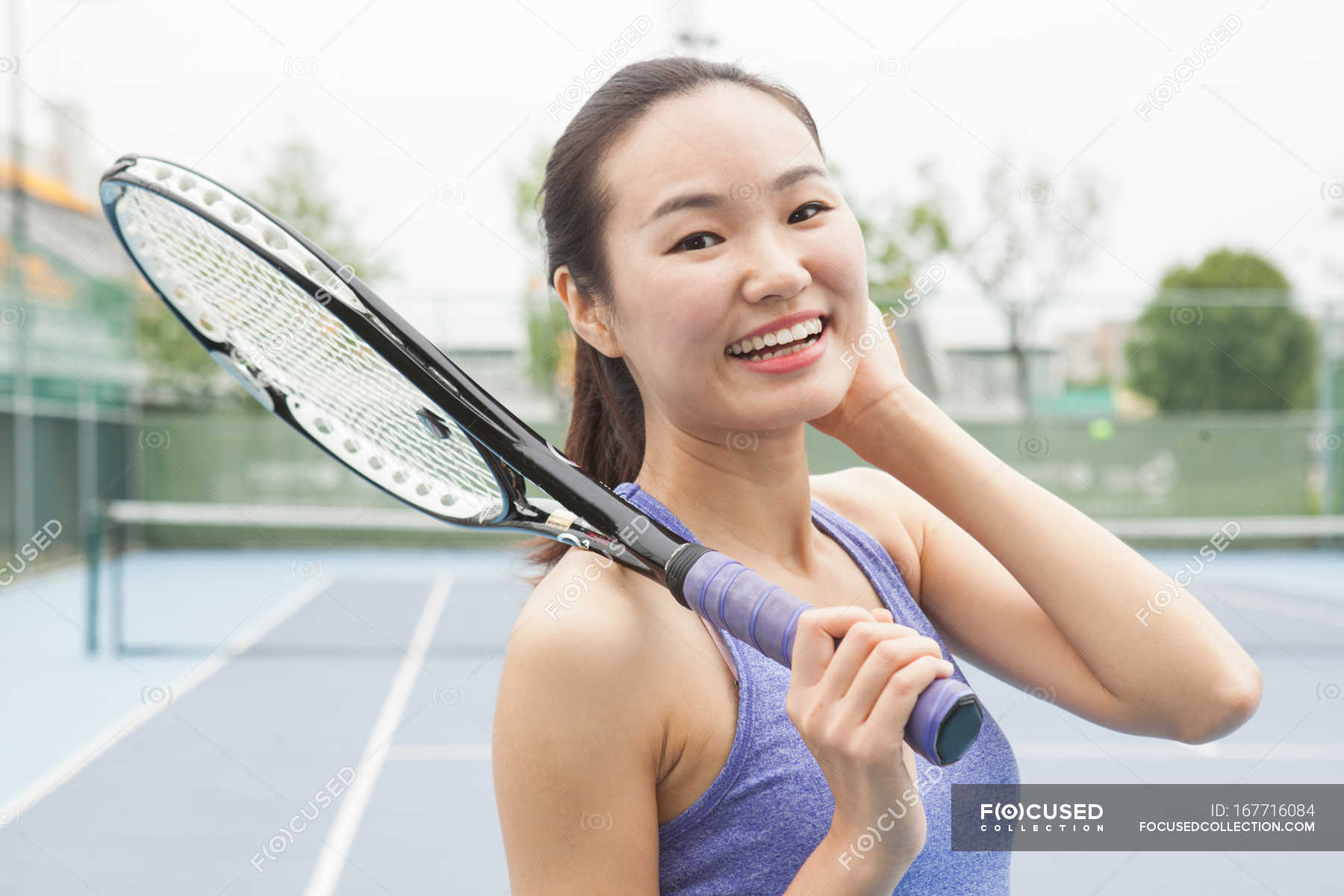 portrait-of-young-female-tennis-player-on-tennis-court-lifestyle