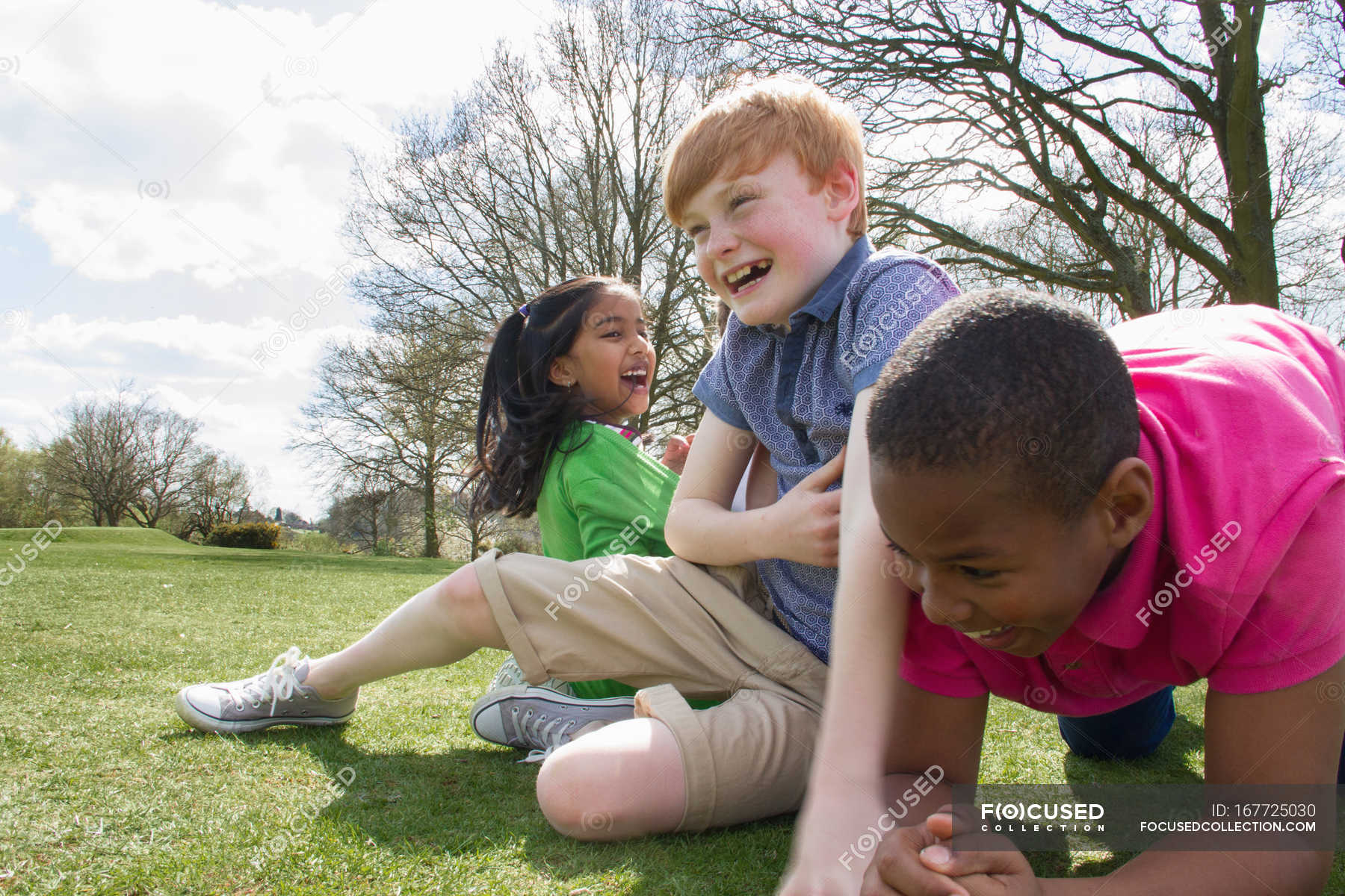 Two boys and a girl playing in field — outdoors, carefree - Stock Photo ...