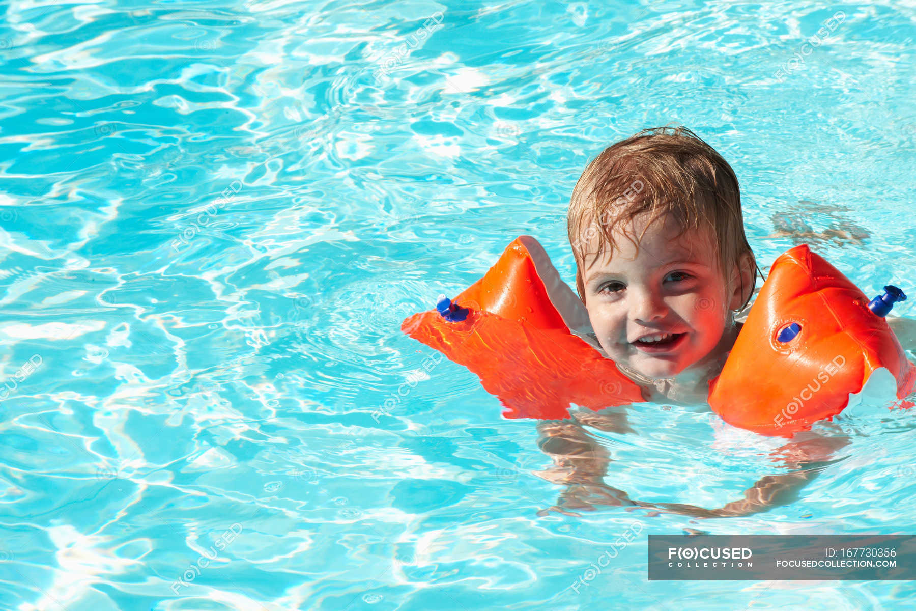 Baby boy swimming with water wings — one person, posing - Stock Photo ...