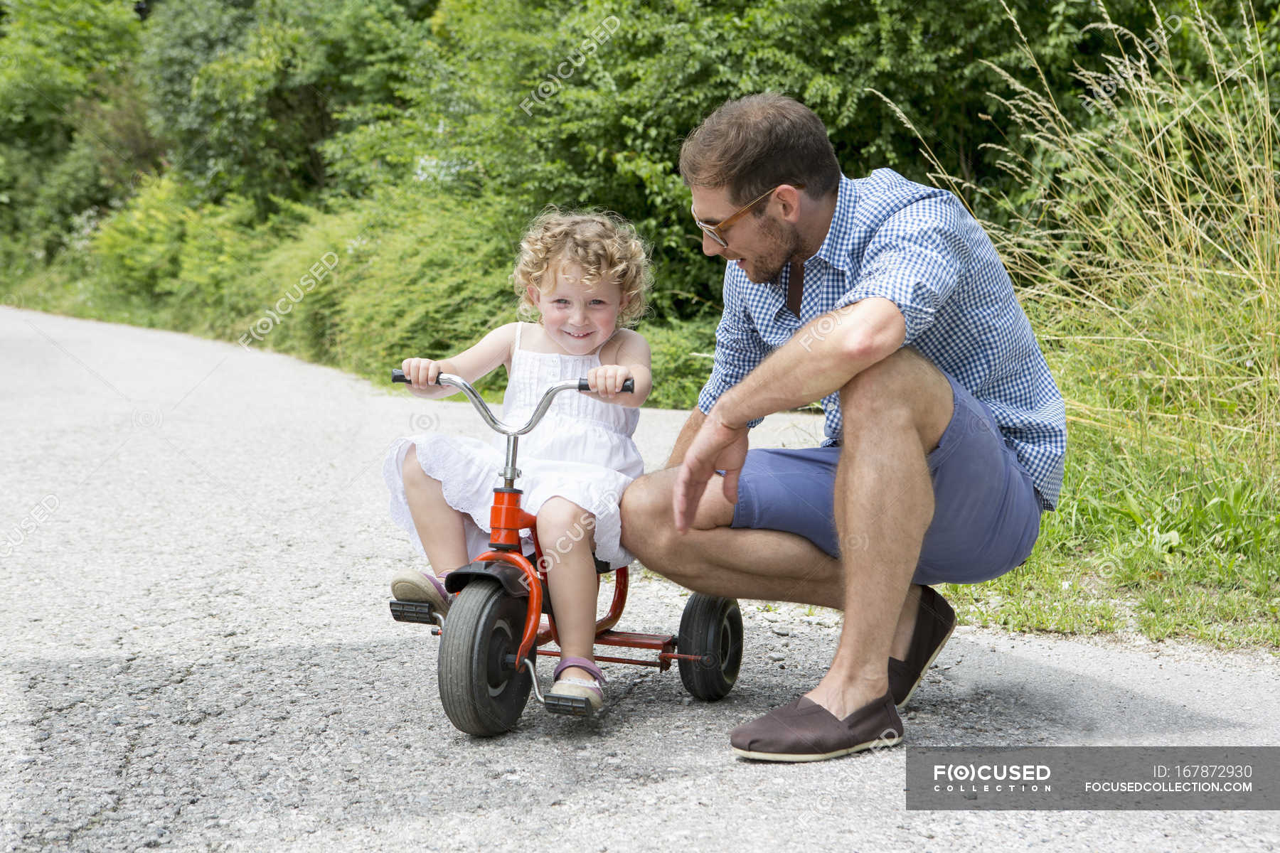 girl riding tricycle