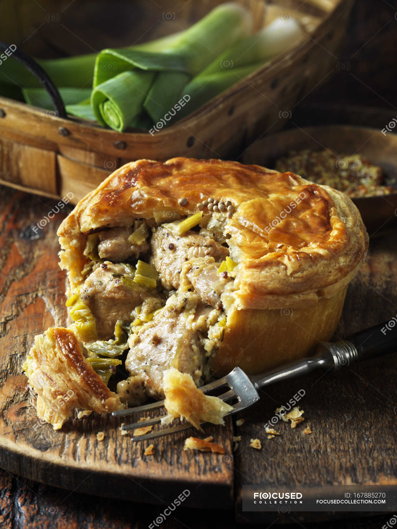 Chicken, leek and wholegrain mustard pie with fork — still life