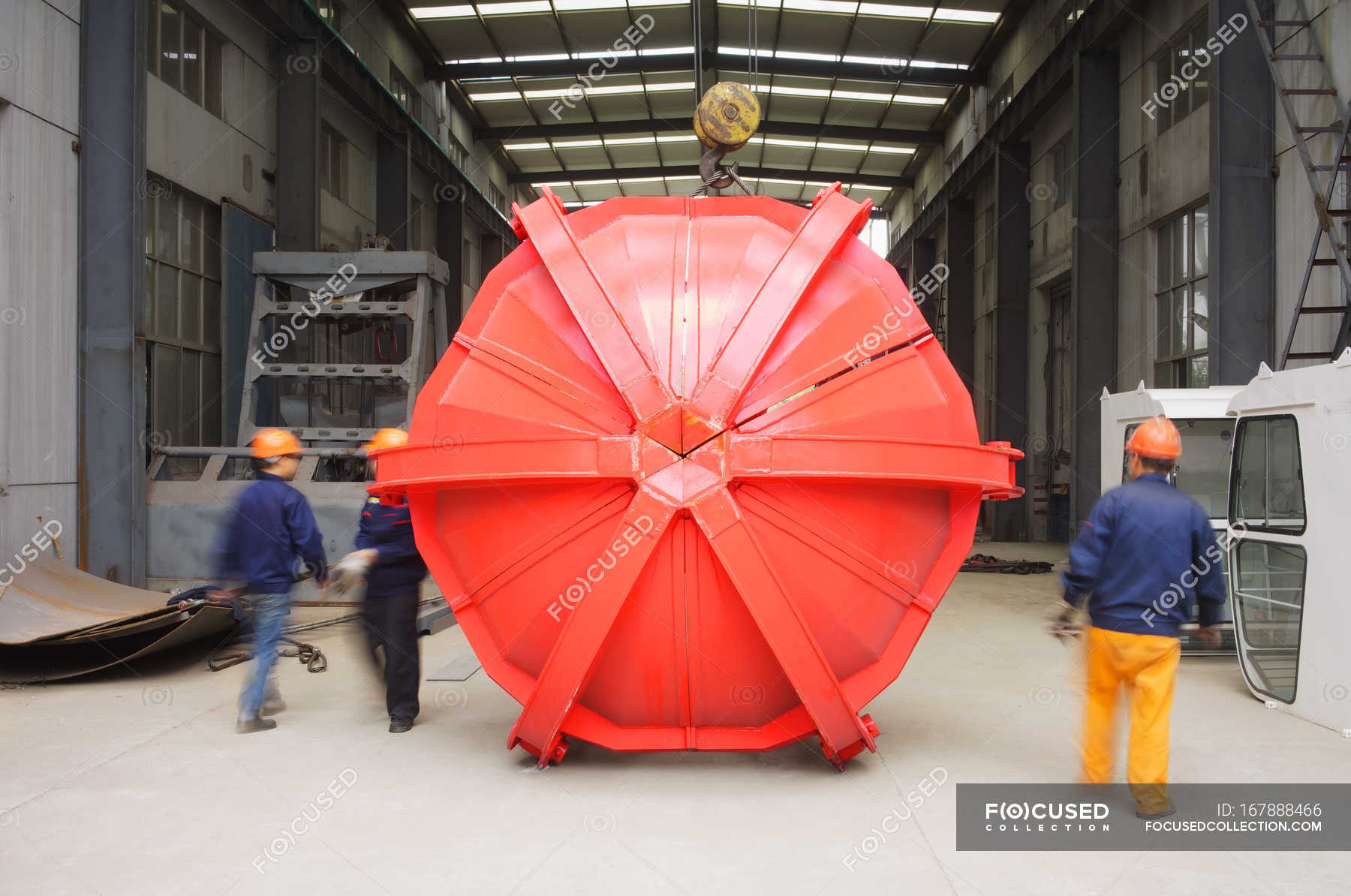Small group of workers in crane manufacturing facility, China