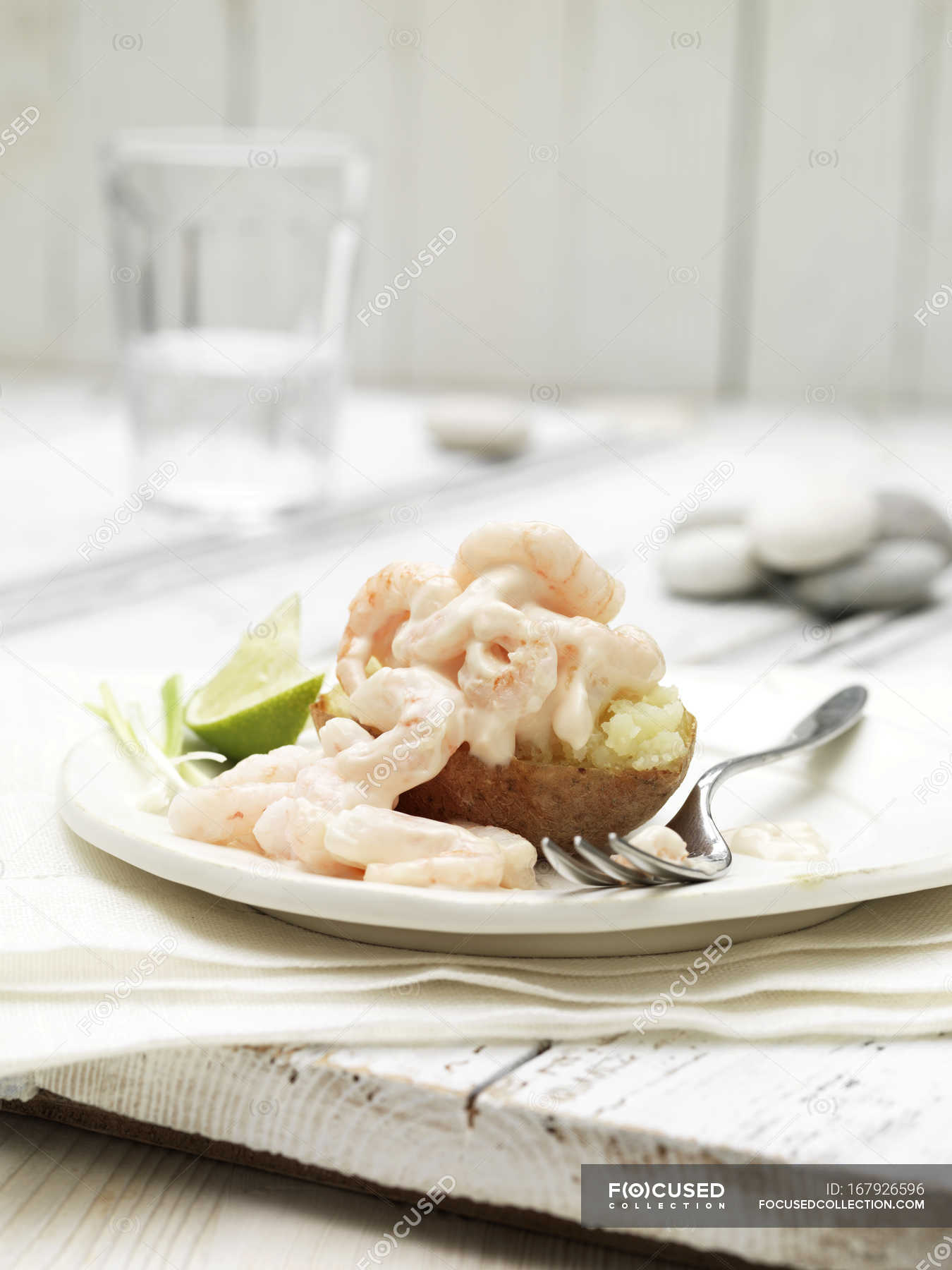 Prawn cocktail jacket potato with slice of lime and spring onion