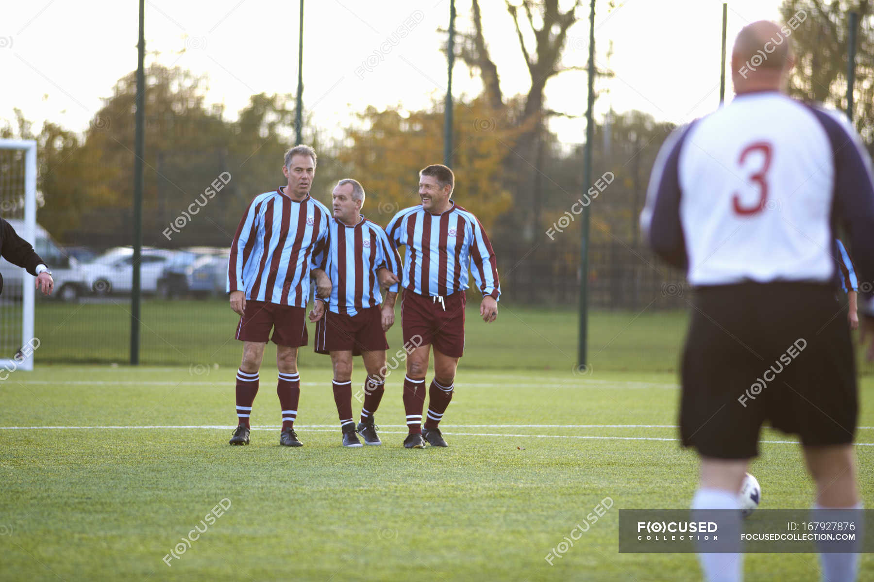 Football Players Forming Wall To Defend Free Kick Challenge Football Match Stock Photo