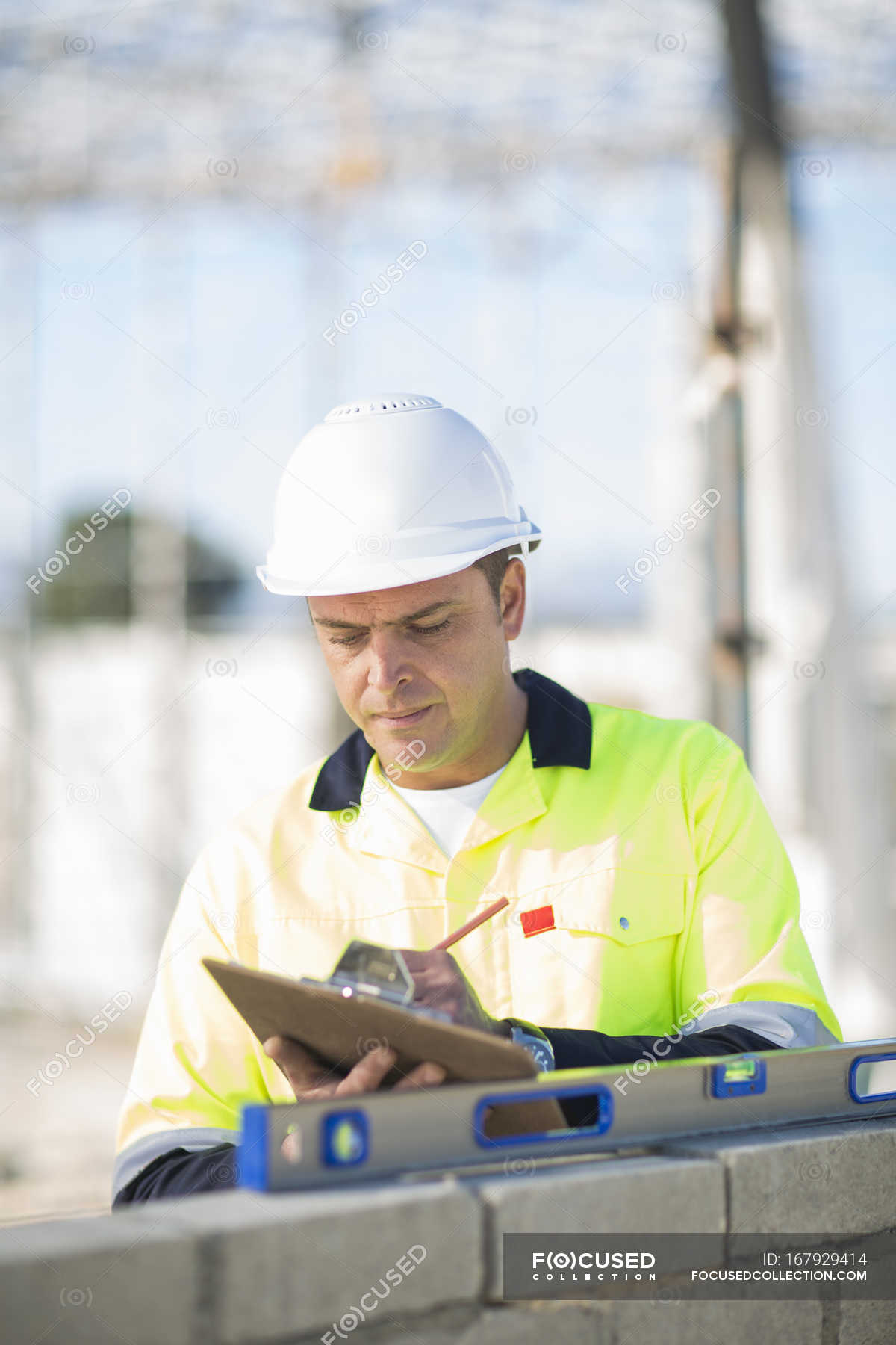 Site Manager Checking Spirit Level On Construction Site Wall Future Built Structure Stock Photo