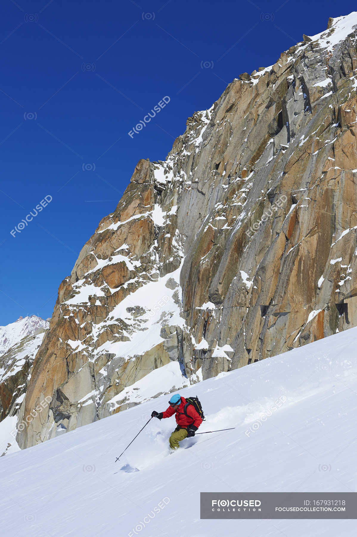 Male skier speeding downhill on Mont Blanc massif, Graian Alps, France ...