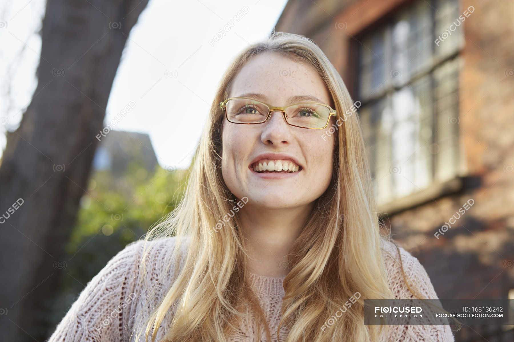 Portrait Of Young Woman Outdoors Long Blonde Hair And Glasses