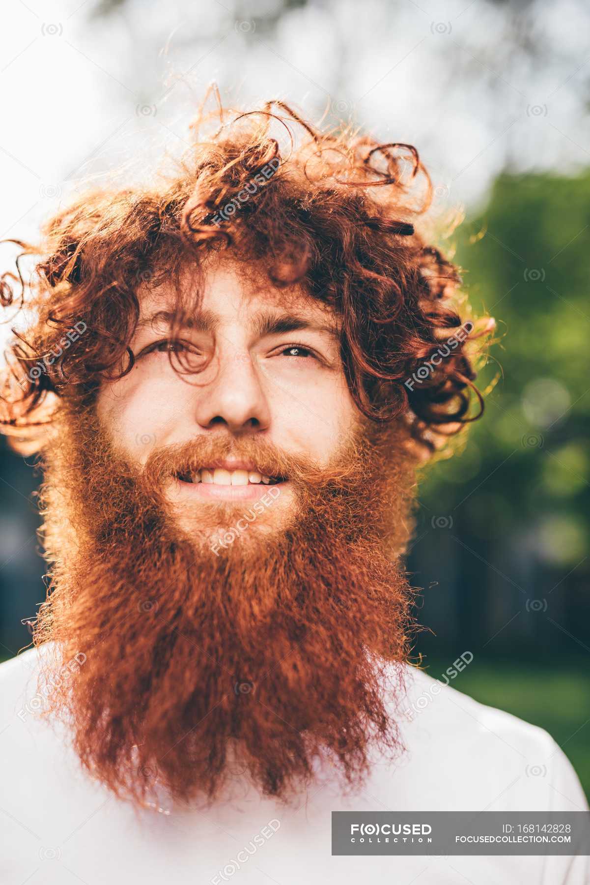 Portrait of young male hipster with curly red hair and beard in park —  leisure, outdoors - Stock Photo | #168142828