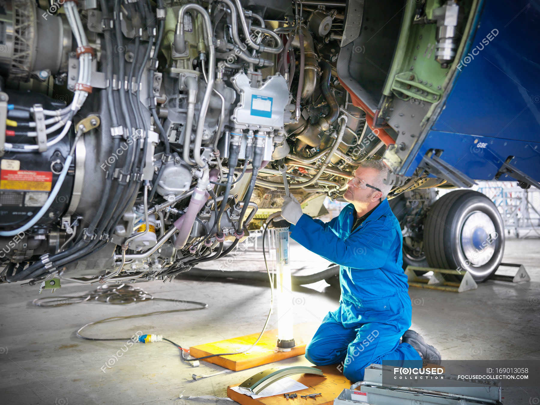Aircraft engineer working on 737 engine in hangar — occupation, factory -  Stock Photo | #169013058