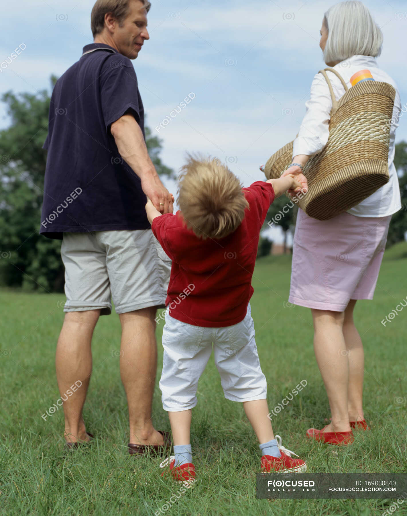 Young boy and parents outside. — walking, Heterosexual Couple - Stock ...