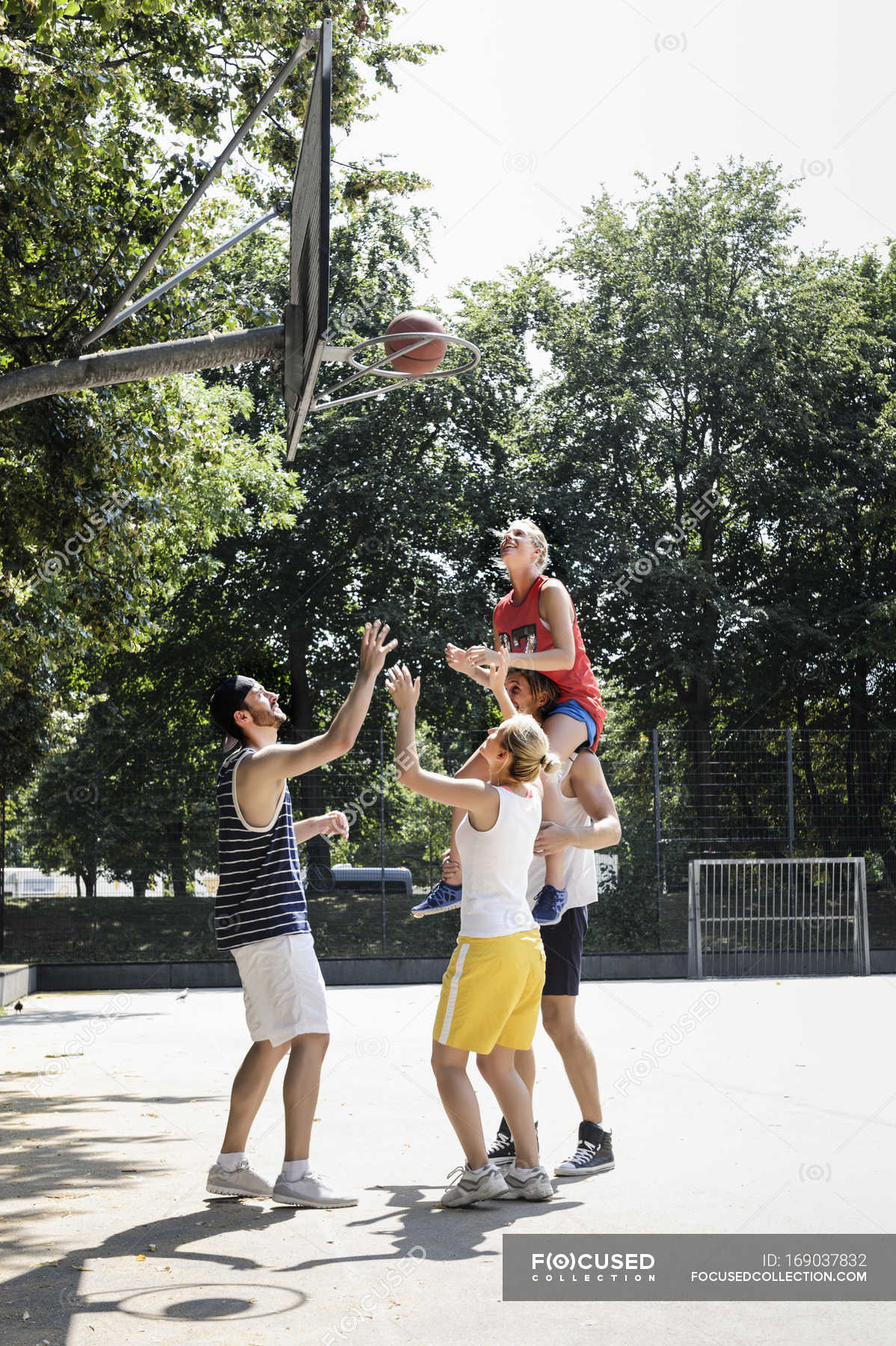 Group of friends having fun playing basketball — Full Length, sunlight ...