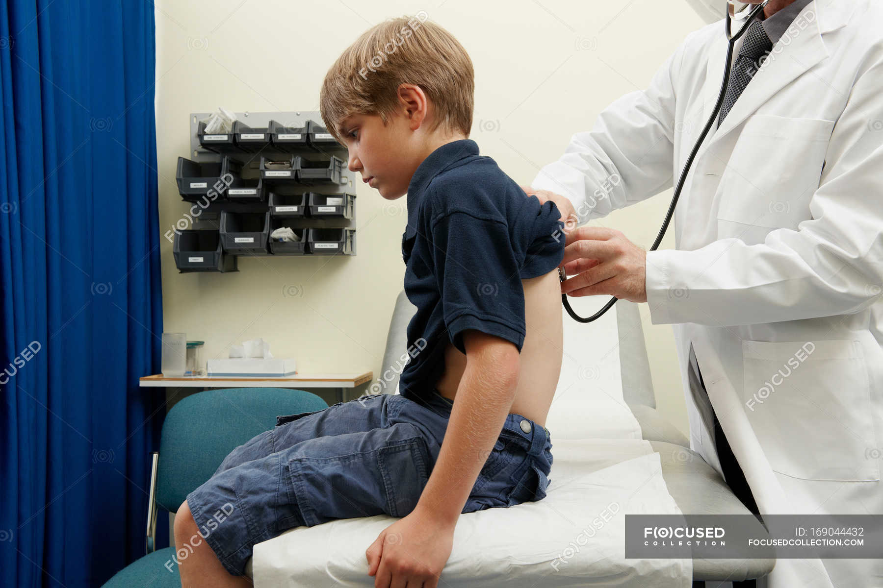 Doctor Examining Young Boy Examination Room Medical Examinatio