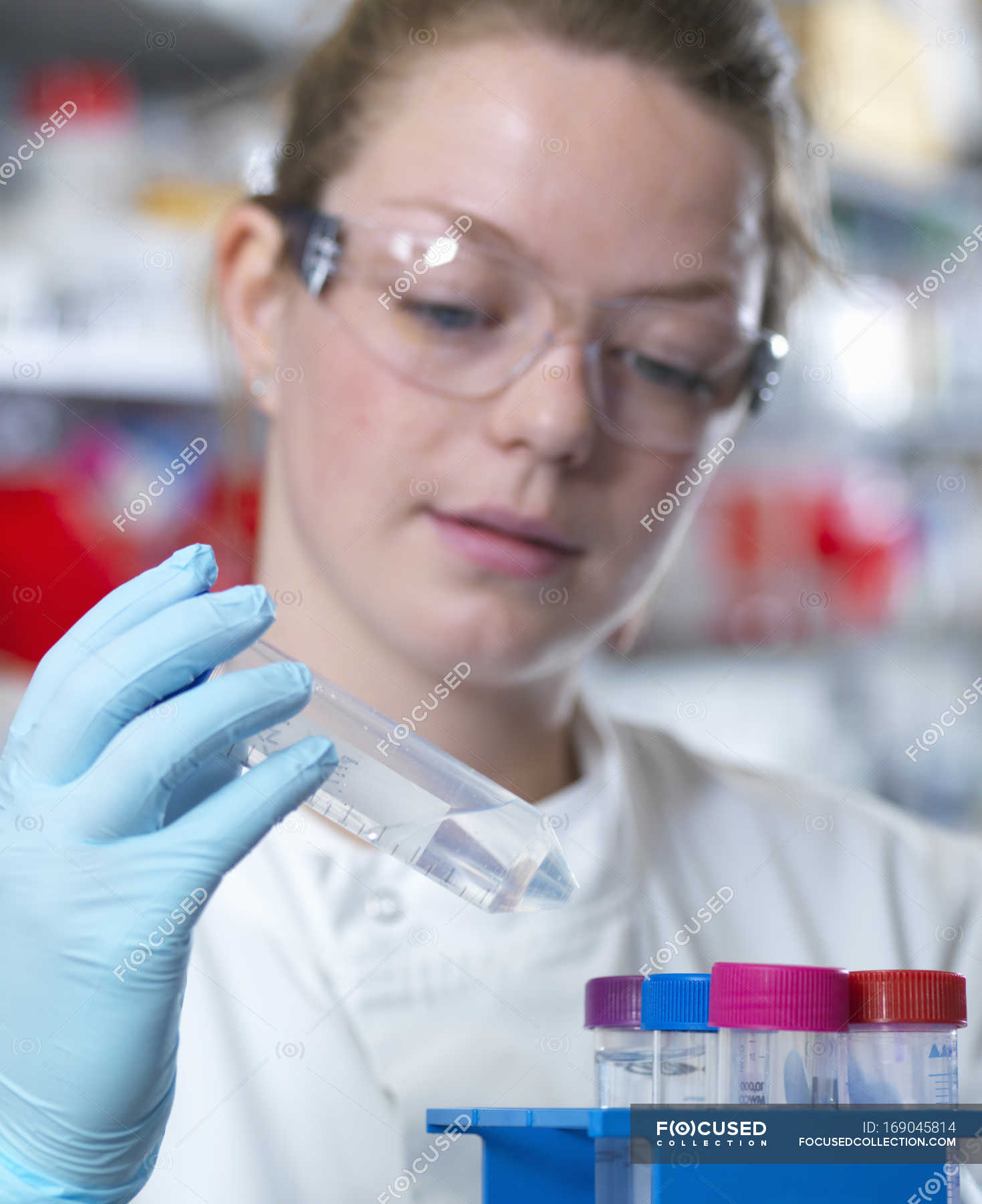 Scientist preparing buffer for antibody purification in laboratory