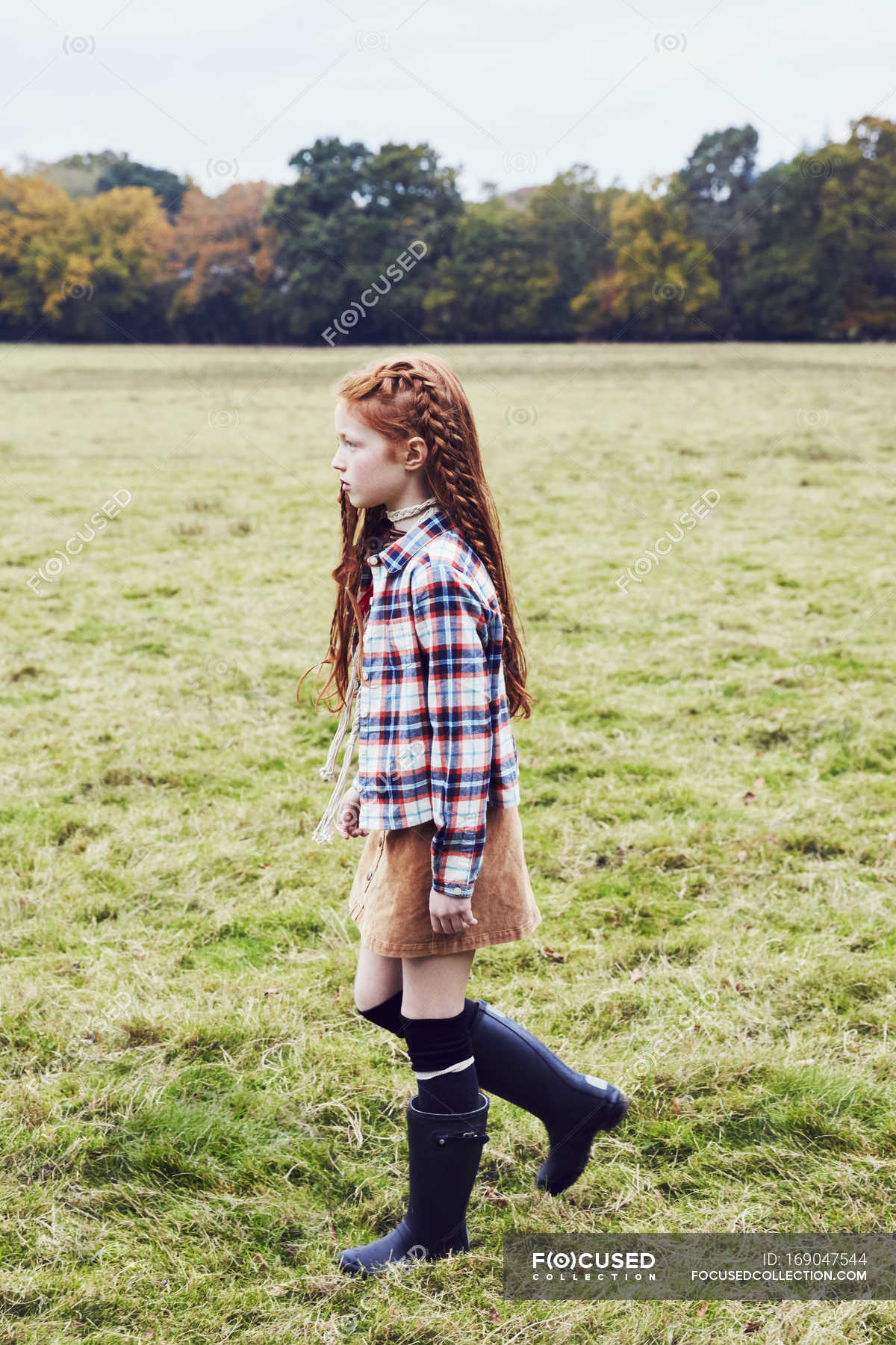 Young girl, walking through field — one person, female Stock Photo