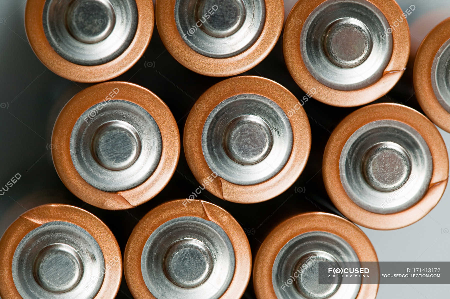 Top view of Batteries placed in a row on grey surface — still life ...