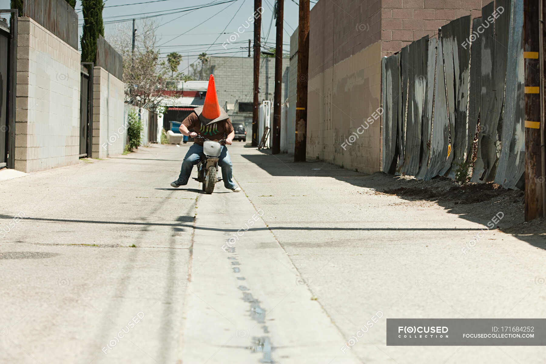 Man with traffic cone on head, riding motorbike — Two People, urban