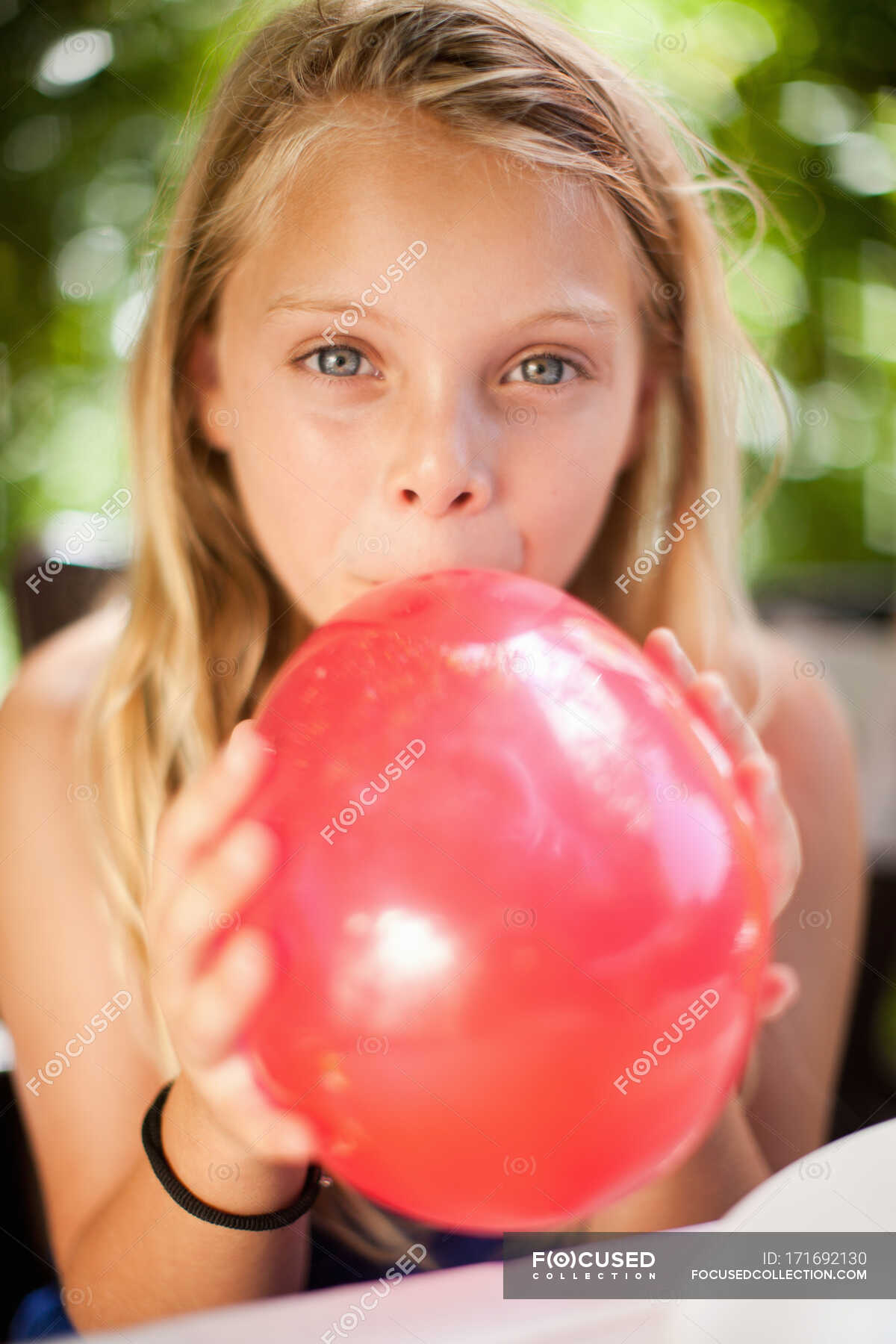 Girls Blowing Balloons