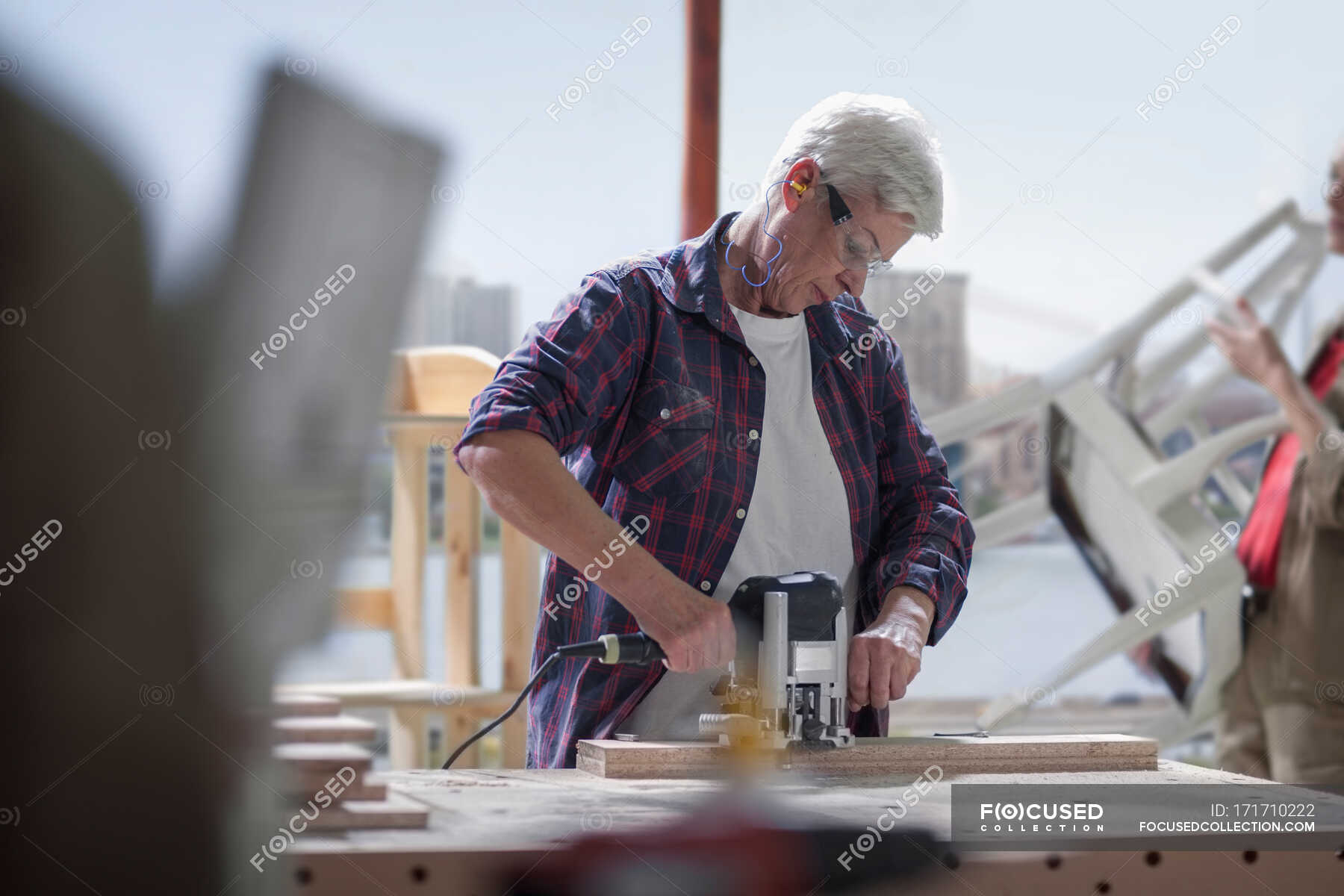 Cape Town, South Africa, woman working in wood workshop — work clothes