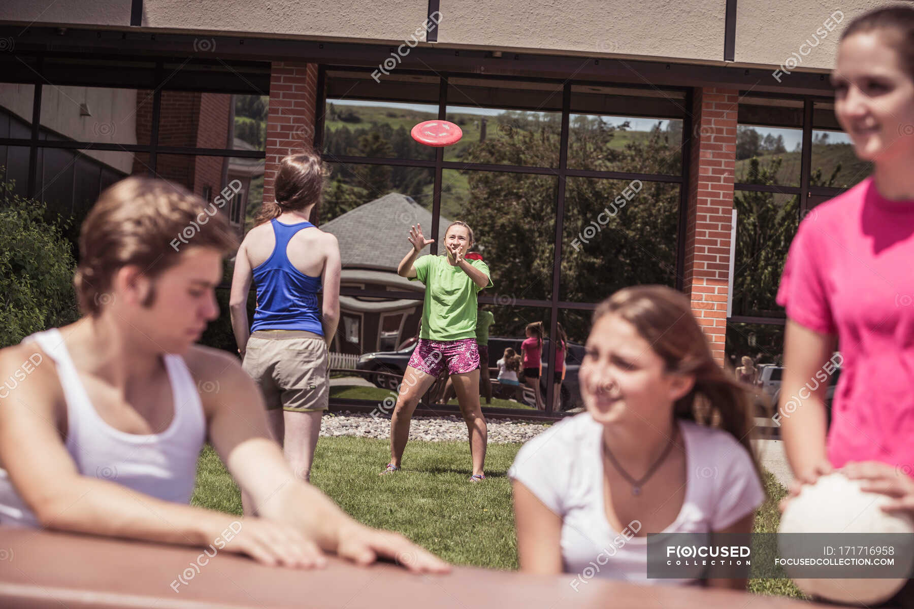 High school volleyball students team talking outside high school