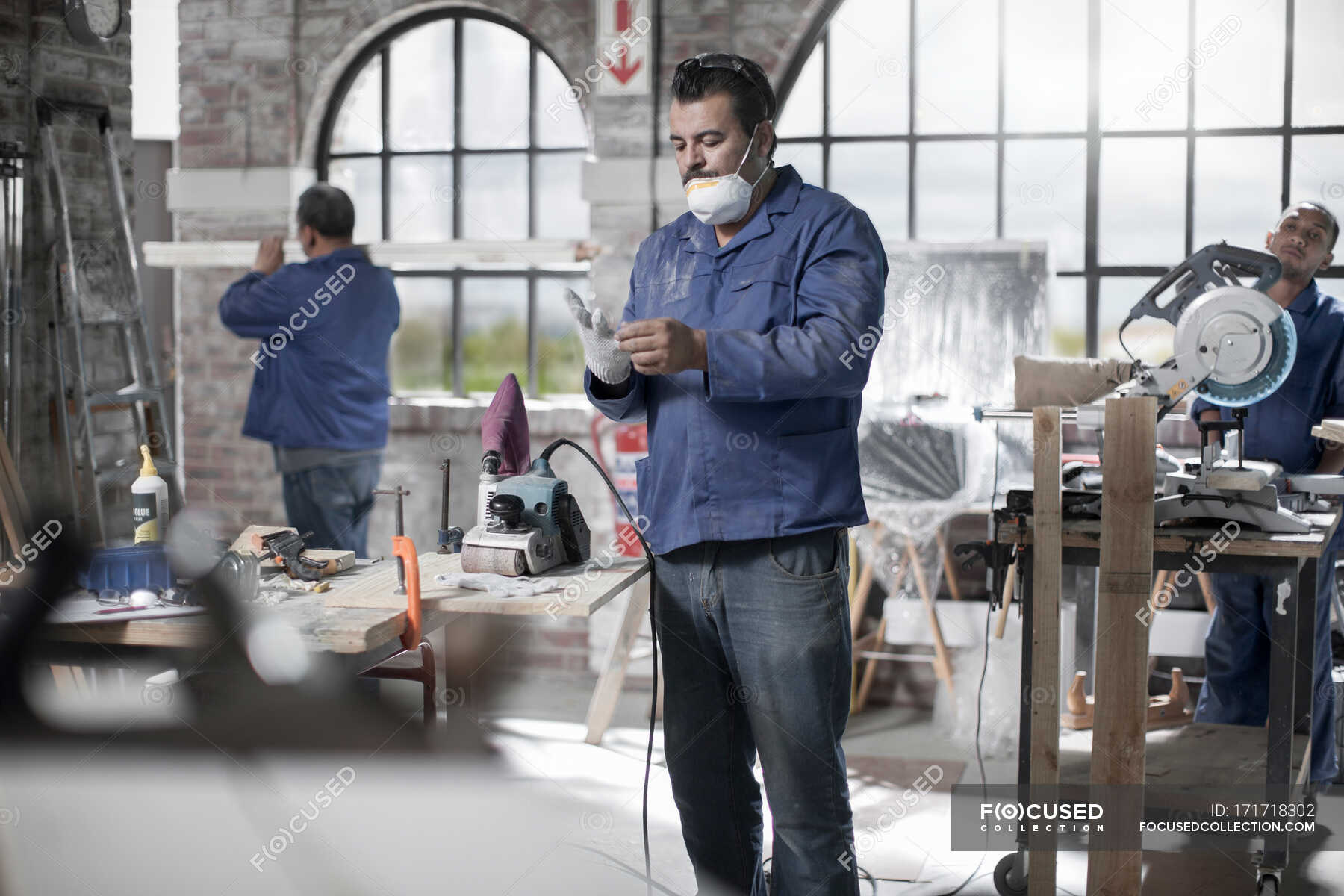 Cape Town, South Africa, machinist safetly applying his gloves before