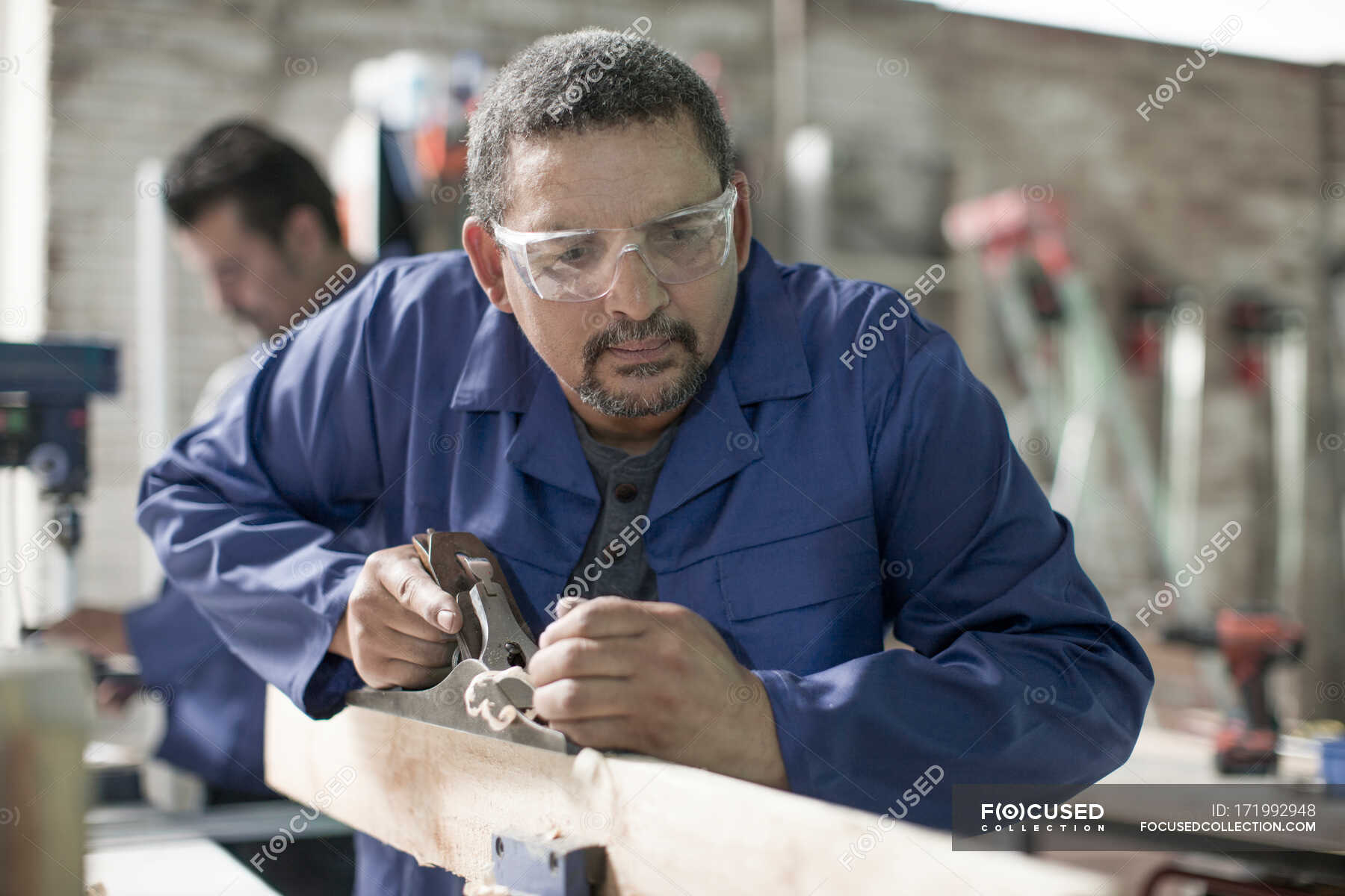 Cape Town, South Africa, machinist carving out wood with carving tool