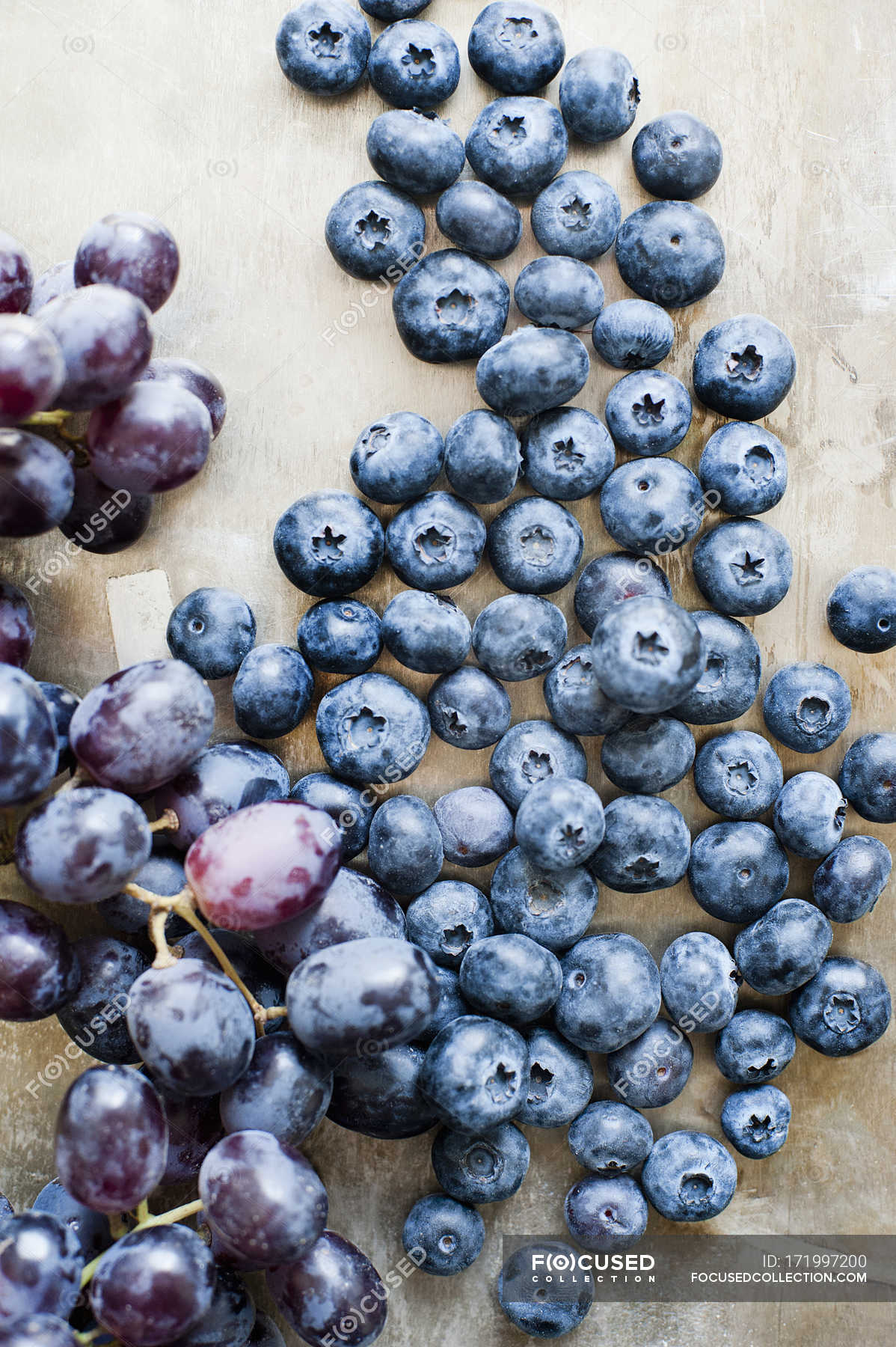 Top view of ripe grapes and blueberries on table — raw, fruits Stock