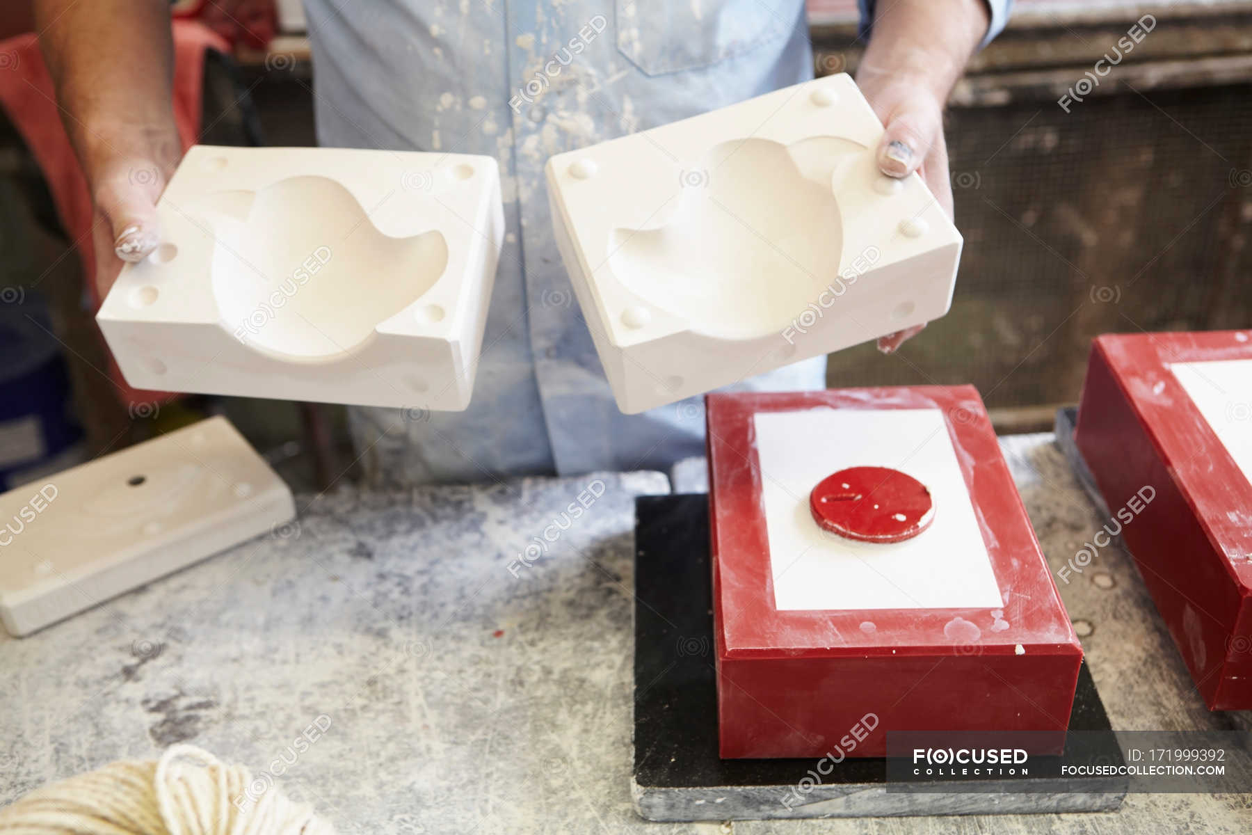 Man holding plaster cast mould in pottery factory — concentration ...