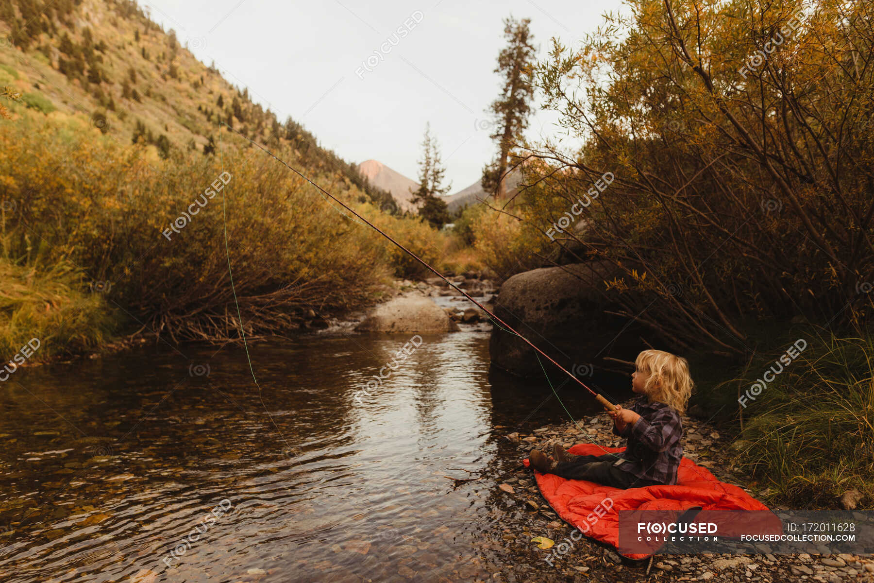 Young boy fish beside creek, Mineral King, Sequoia National Park ...