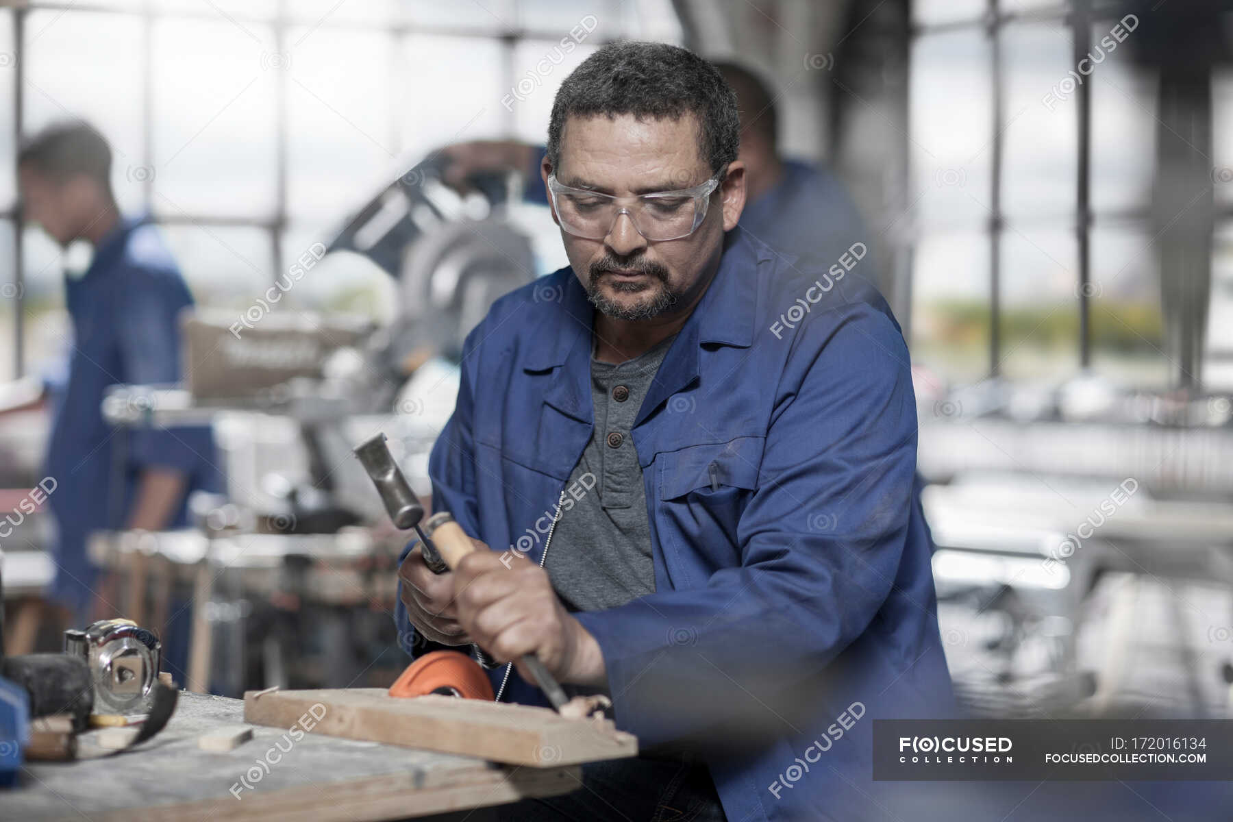 Cape Town, South Africa, machinist in cutting out wood with wood cutting tools — making