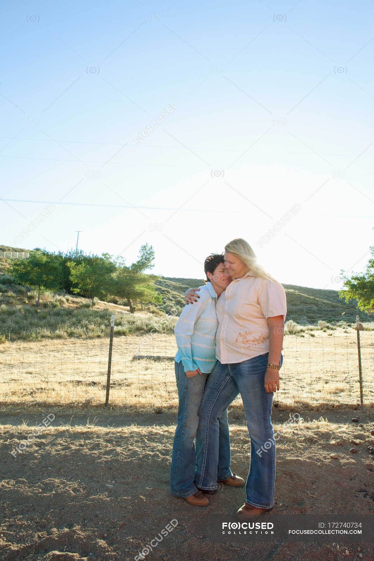 Mature lesbian couple embracing on ranch — consolation, 45 to 49 years -  Stock Photo | #172740734