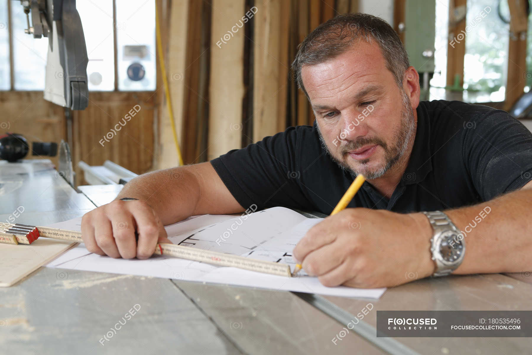 Man Drawing Blueprint While Sitting At Table Workshop Precision Stock Photo 180535496