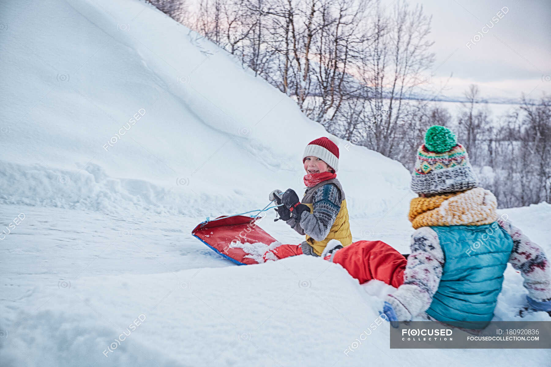 Two brothers on toboggan on snow covered hill, Hemavan,Sweden
