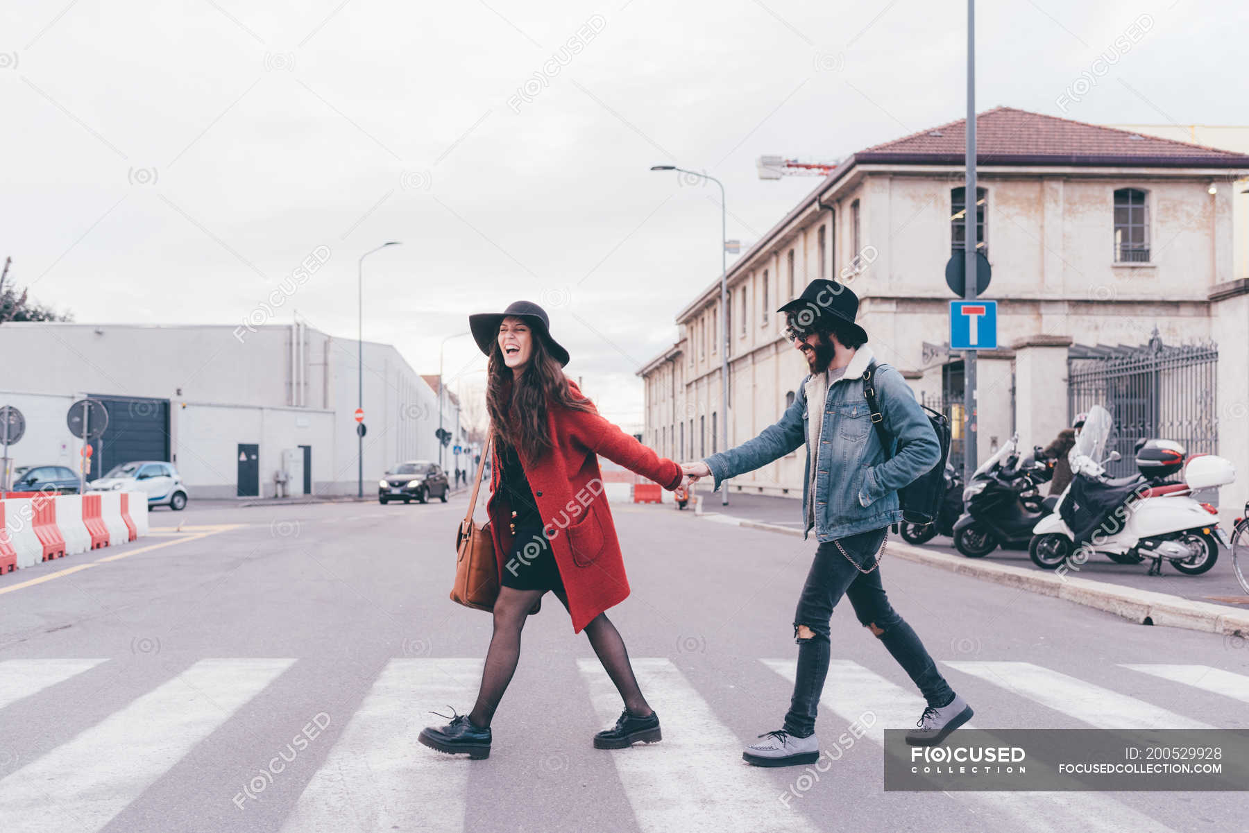 motorcycle couple holding hands